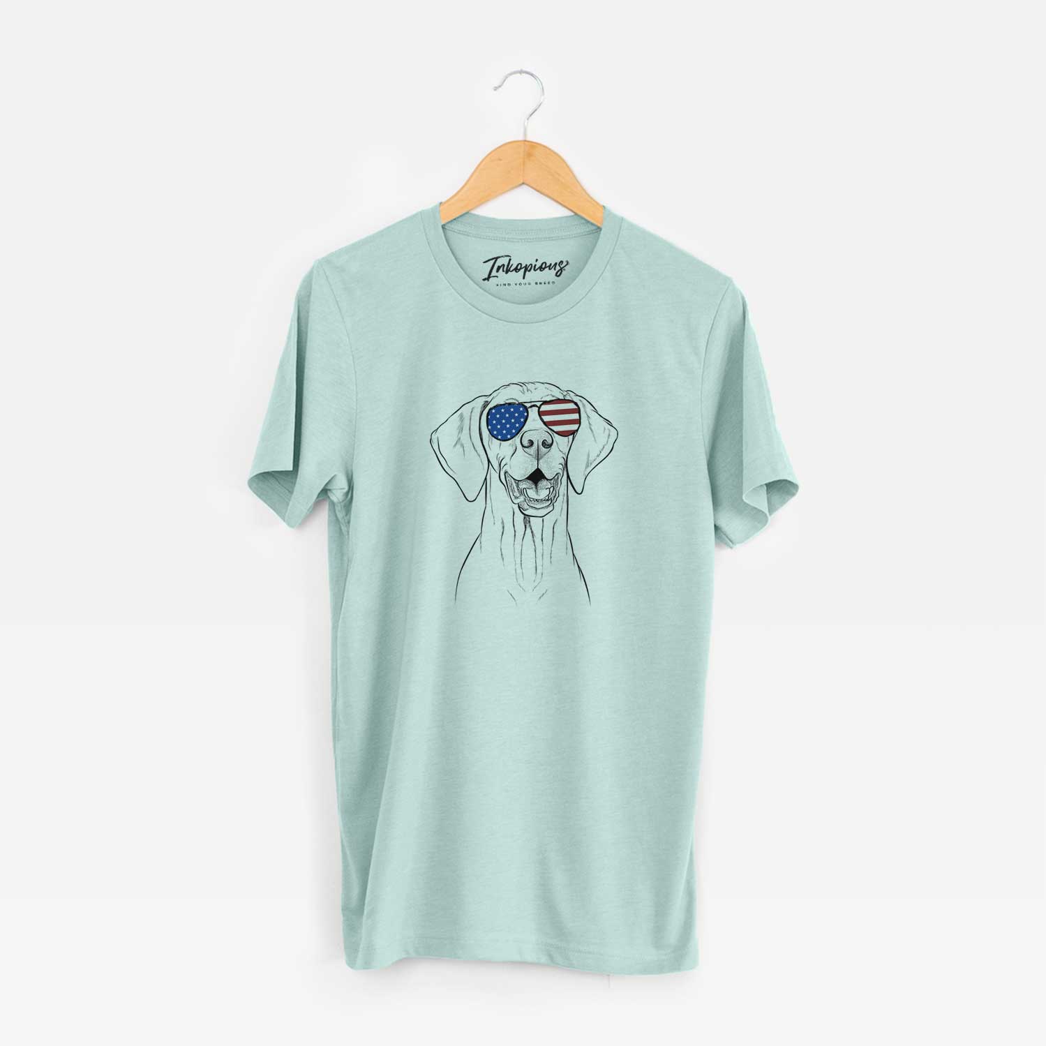 Hand-drawn sketch of Wesley the Vizsla wearing American flag sunglasses on a Heather Sage Unisex crewneck