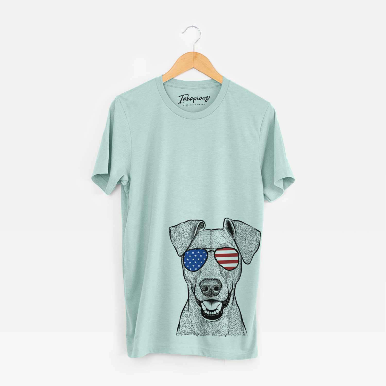 Hand-drawn sketch of Willow the German Pinscher wearing American flag sunglasses on a Heather Sage Unisex crewneck