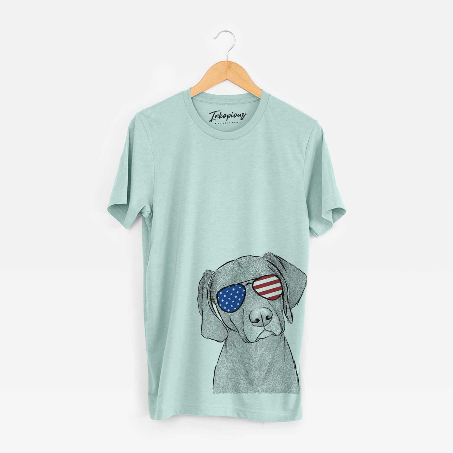 Hand-drawn sketch of Willow the Weizsla wearing American flag sunglasses on a Heather Sage Unisex crewneck