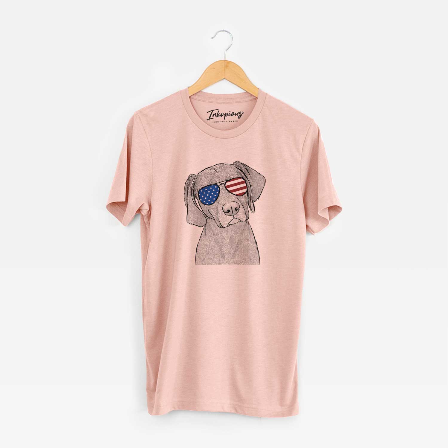 Hand-drawn sketch of Willow the Weizsla wearing American flag sunglasses on a Peach Unisex crewneck