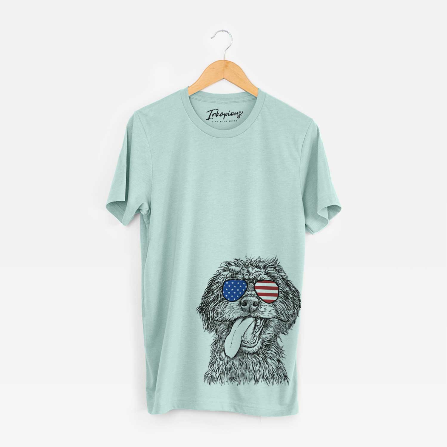 Hand-drawn sketch of Winnie the Mini Aussiedoodle wearing American flag sunglasses on a Heather Sage Unisex crewneck