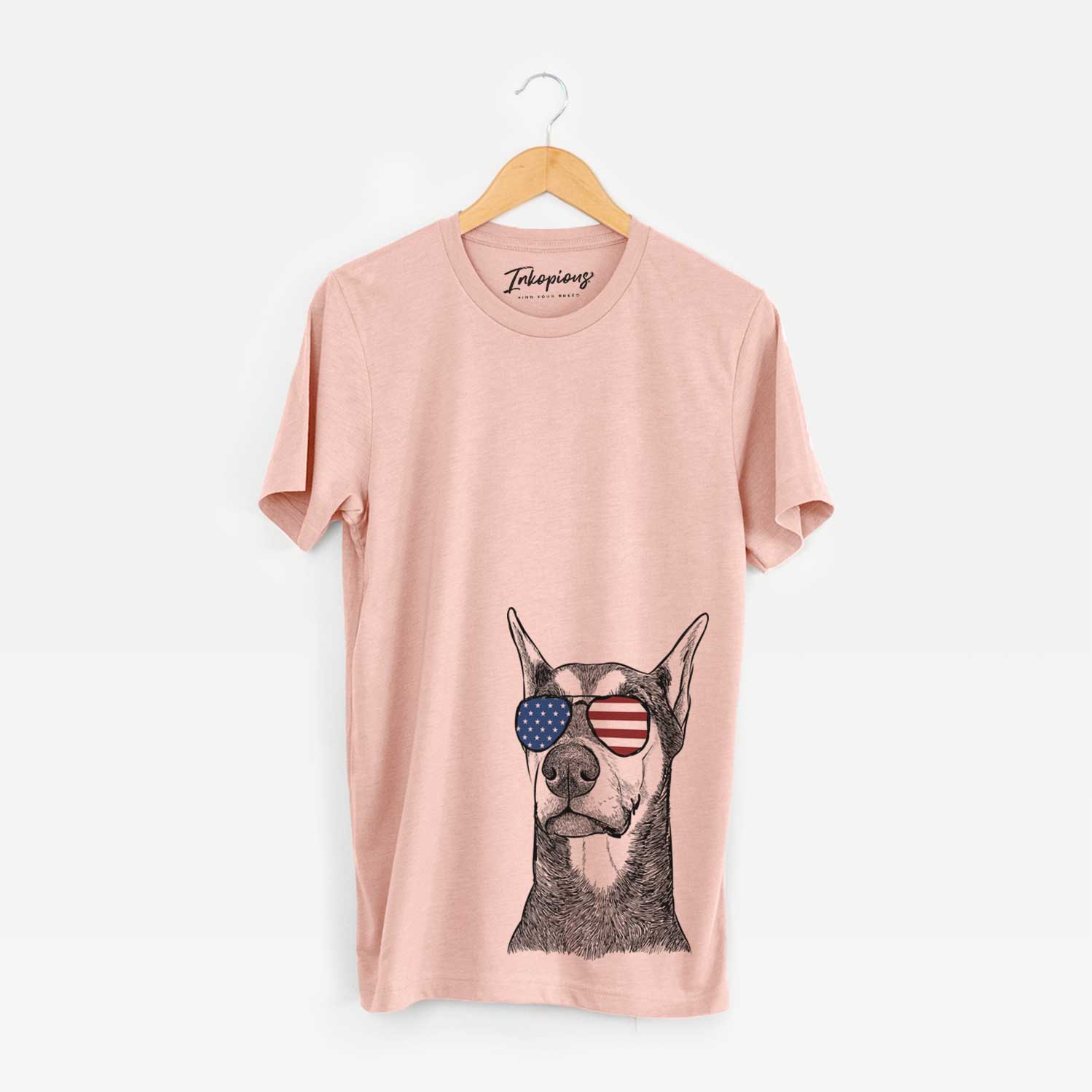 Hand-drawn sketch of Zeus the Doberman Pinscher wearing American flag sunglasses on a Peach Unisex crewneck
