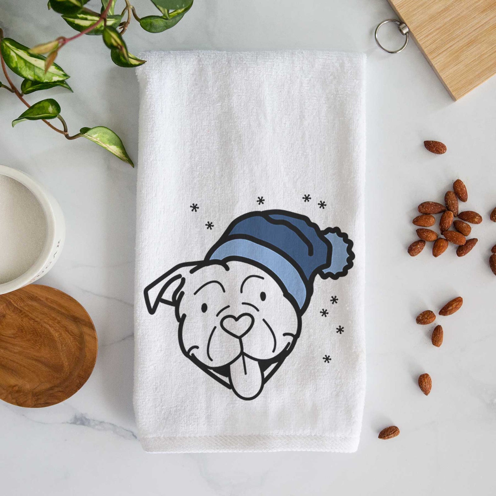 Minimalist line drawing of an American Bulldog wearing a winter beanie on a decorative hand towel