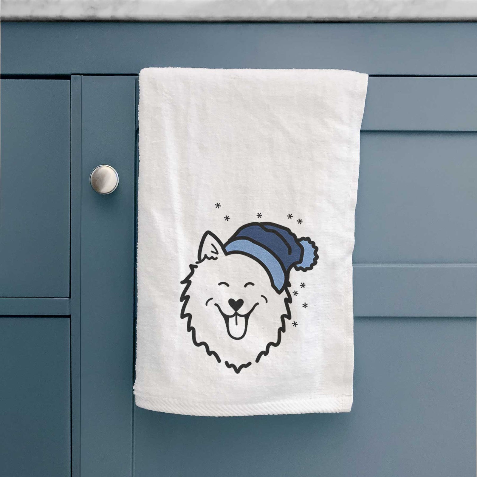Minimalist line drawing of an American Eskimo wearing a winter beanie on a decorative hand towel