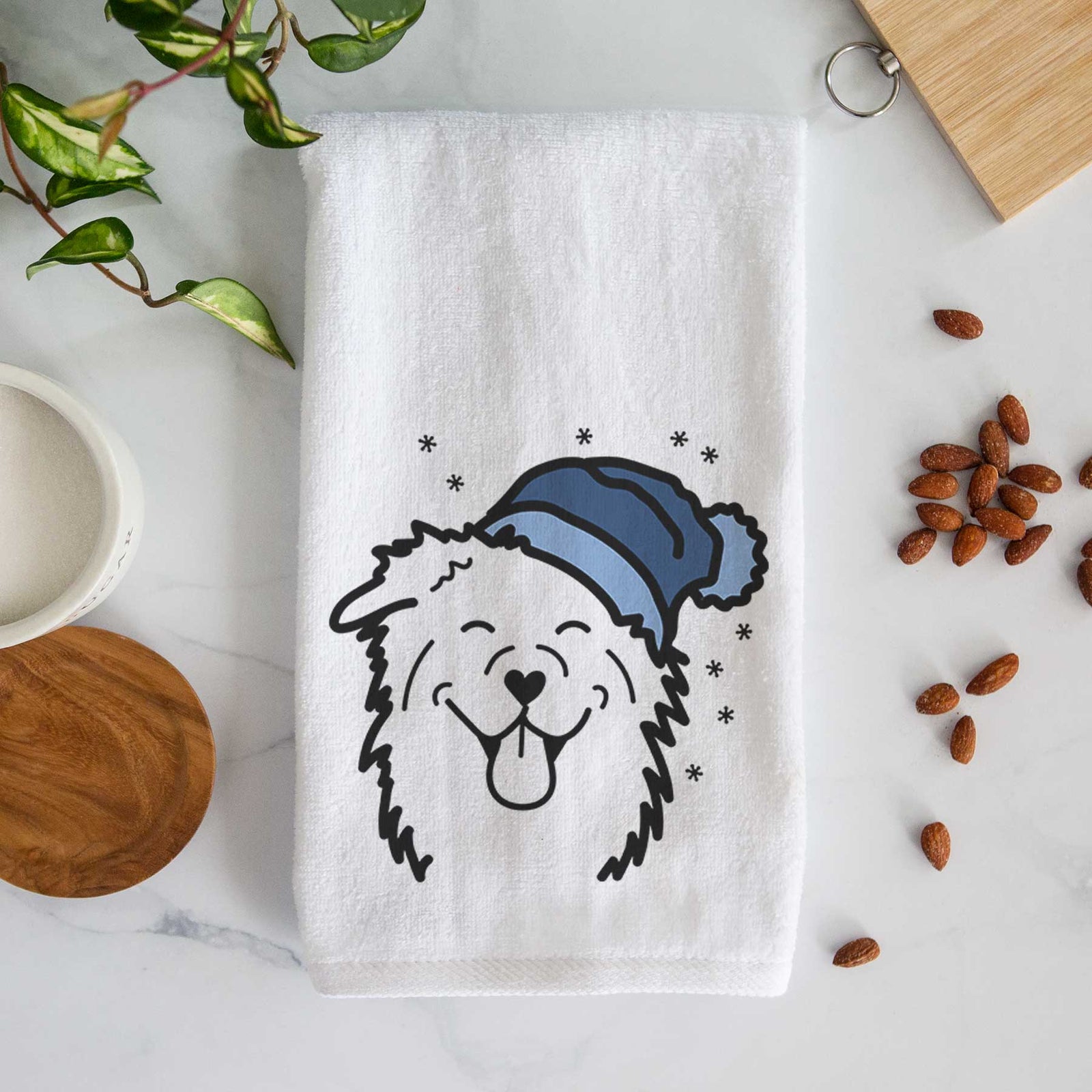 Minimalist line drawing of an Australian Shepherd wearing a winter beanie on a decorative hand towel