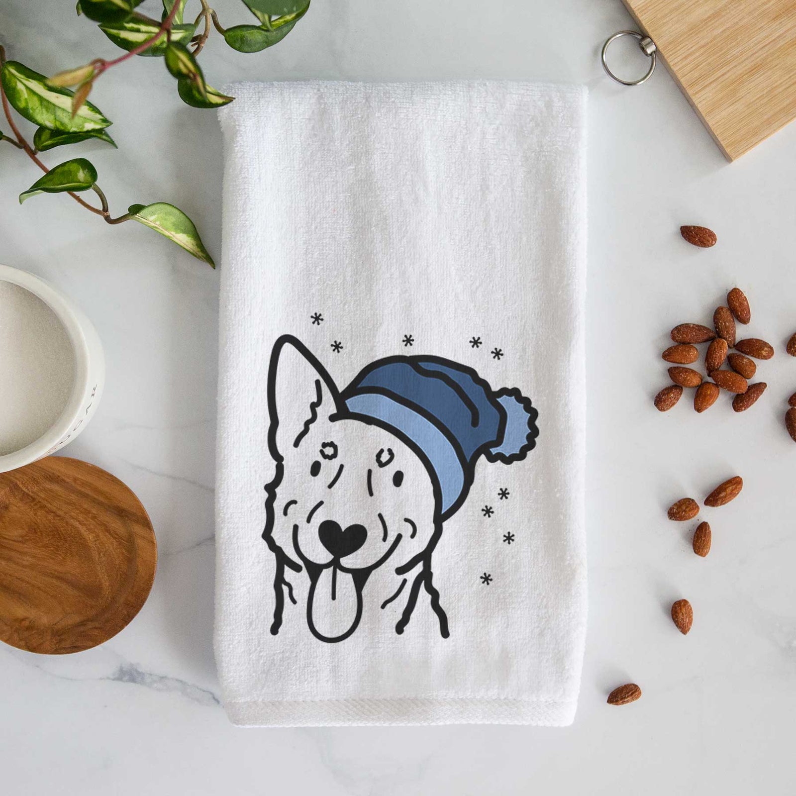 Minimalist line drawing of an Australian Cattle Dog wearing a winter beanie on a decorative hand towel
