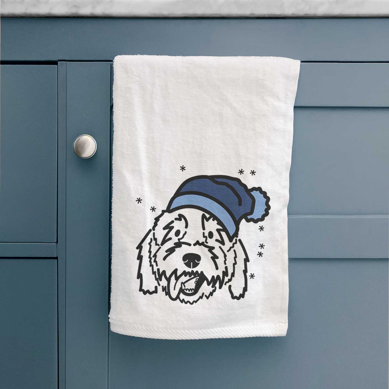 Minimalist line drawing of Barry the Goldendoodle wearing a winter beanie on a decorative hand towel