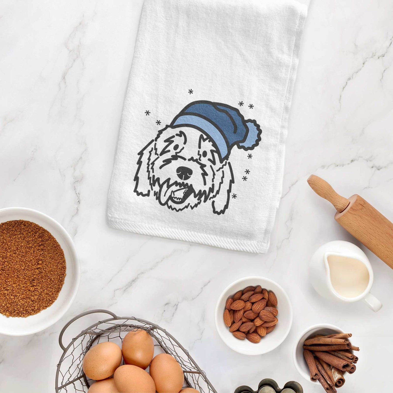 Minimalist line drawing of Barry the Goldendoodle wearing a winter beanie on a decorative hand towel