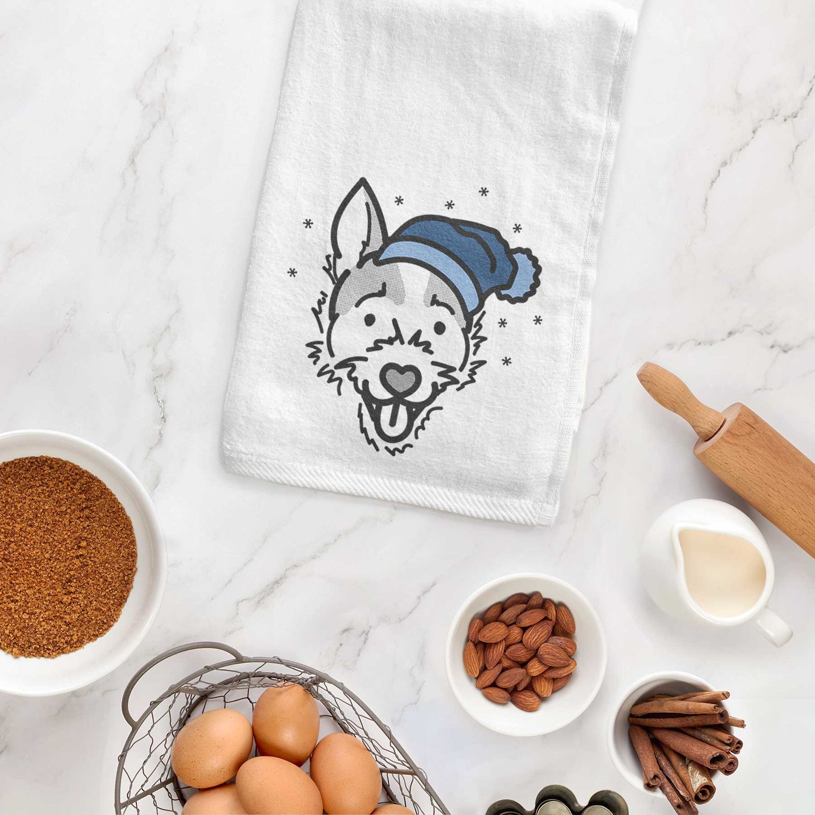 Minimalist line drawing of Baxter the Jack Russell Terrier wearing a winter beanie on a decorative hand towel