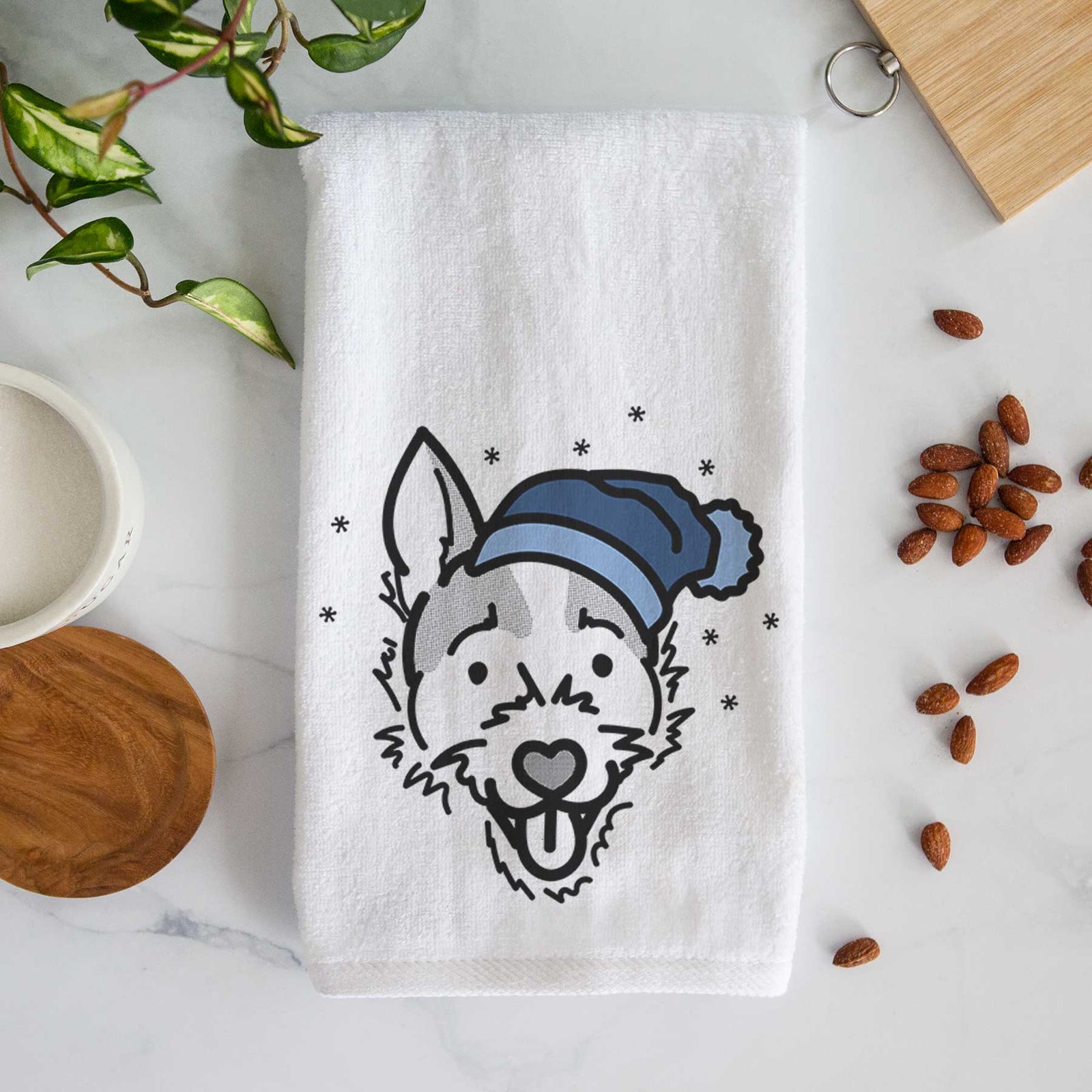 Minimalist line drawing of Baxter the Jack Russell Terrier wearing a winter beanie on a decorative hand towel