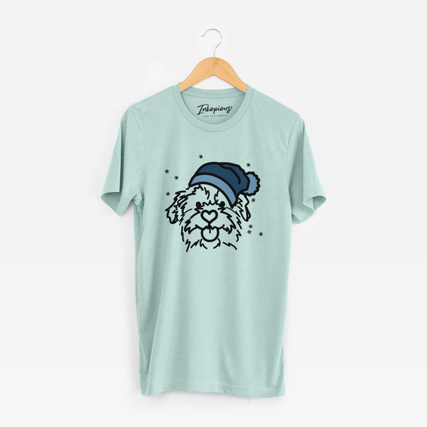 Minimalist line drawing of Bea the Mixed Breed wearing a winter beanie on a Heather Sage Unisex crewneck