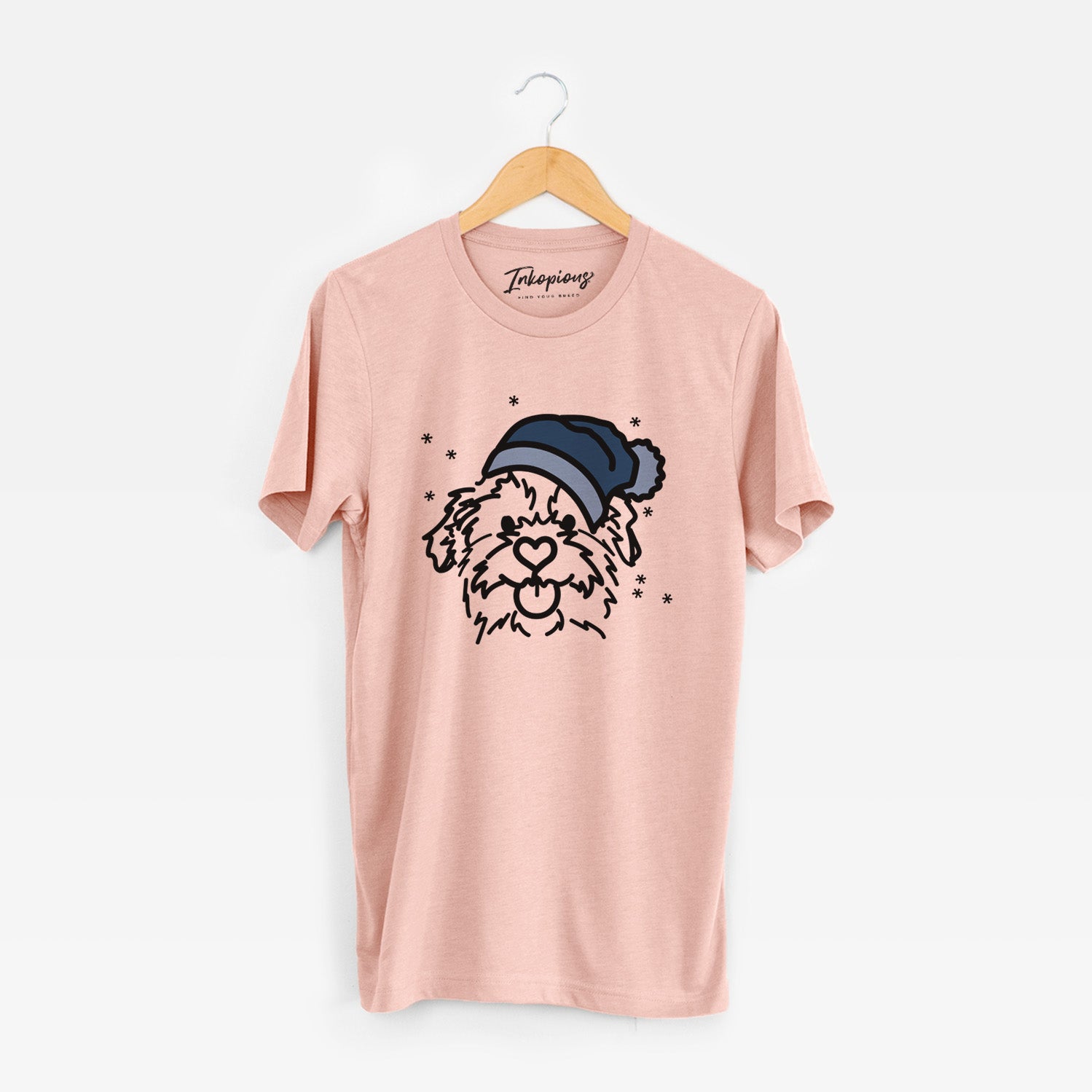 Minimalist line drawing of Bea the Mixed Breed wearing a winter beanie on a Peach Unisex crewneck