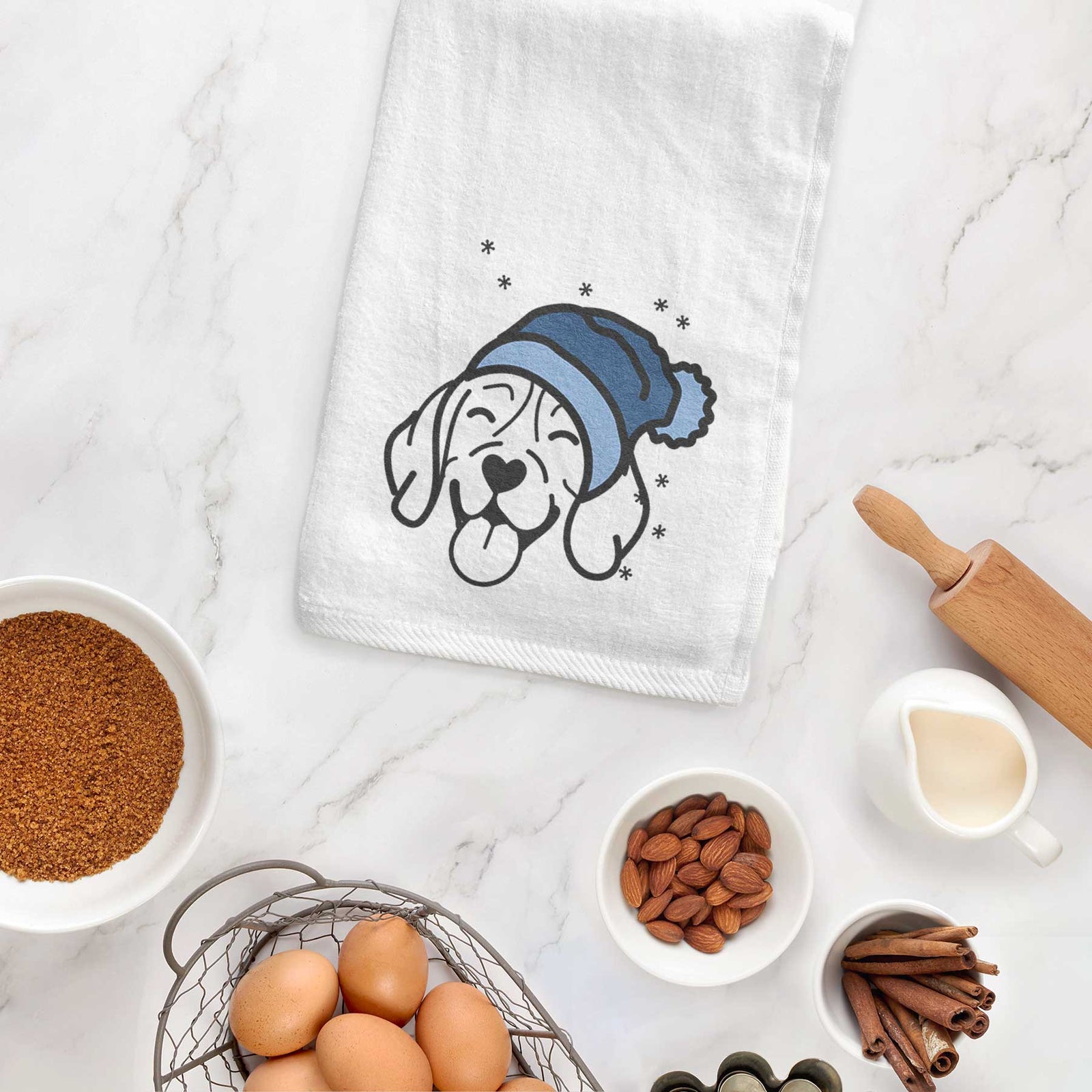 Minimalist line drawing of a Beagle wearing a winter beanie on a decorative hand towel