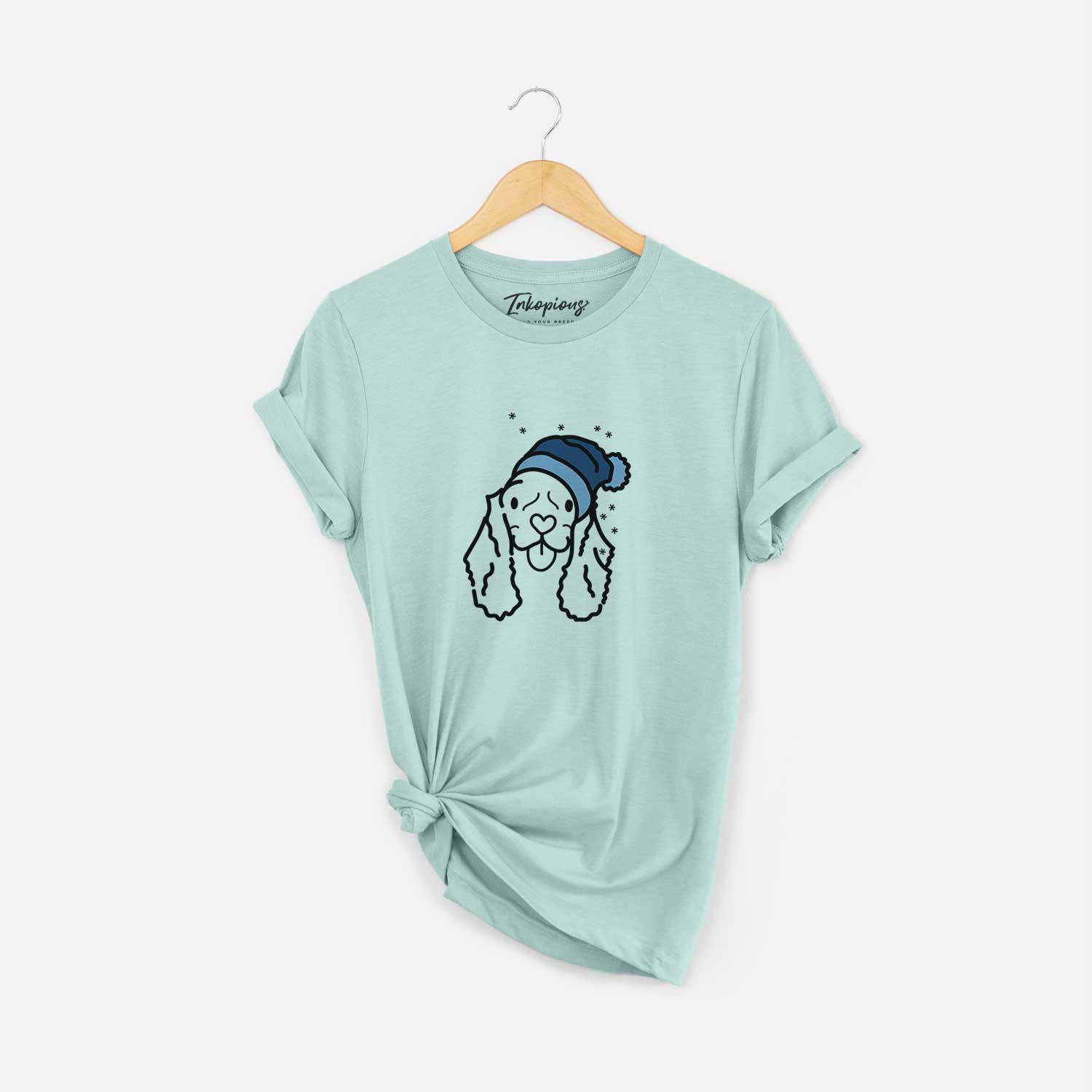 Minimalist line drawing of Bella the American Cocker Spaniel wearing a winter beanie on a Heather Sage Unisex crewneck