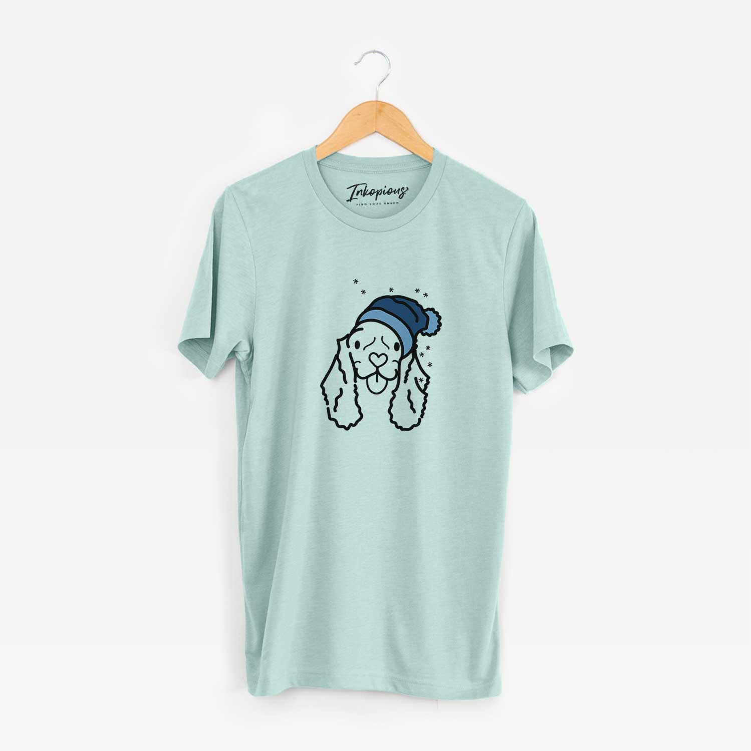 Minimalist line drawing of Bella the American Cocker Spaniel wearing a winter beanie on a Heather Sage Unisex crewneck