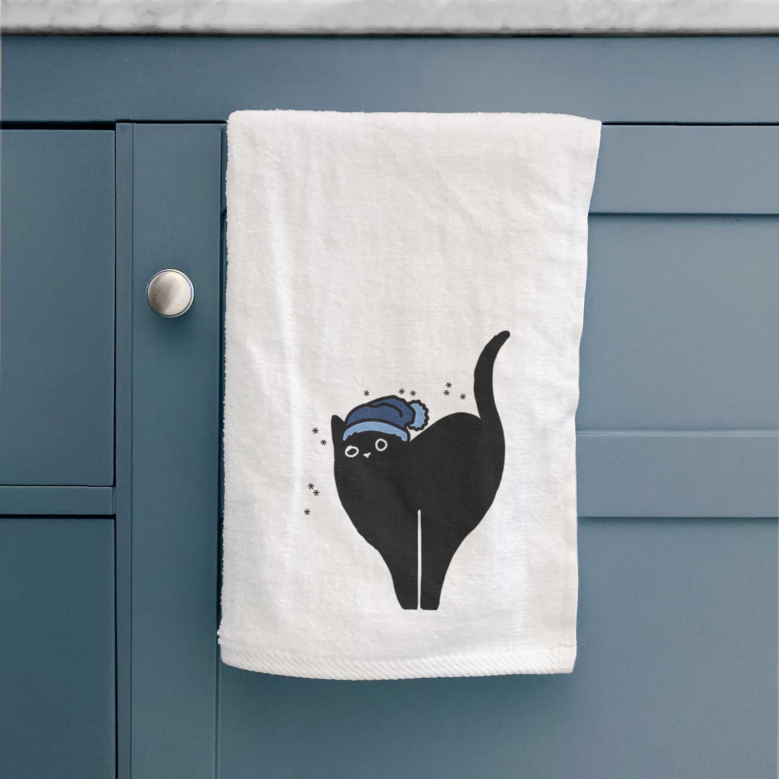 Minimalist line drawing of Bella the Black Cat wearing a winter beanie on a decorative hand towel