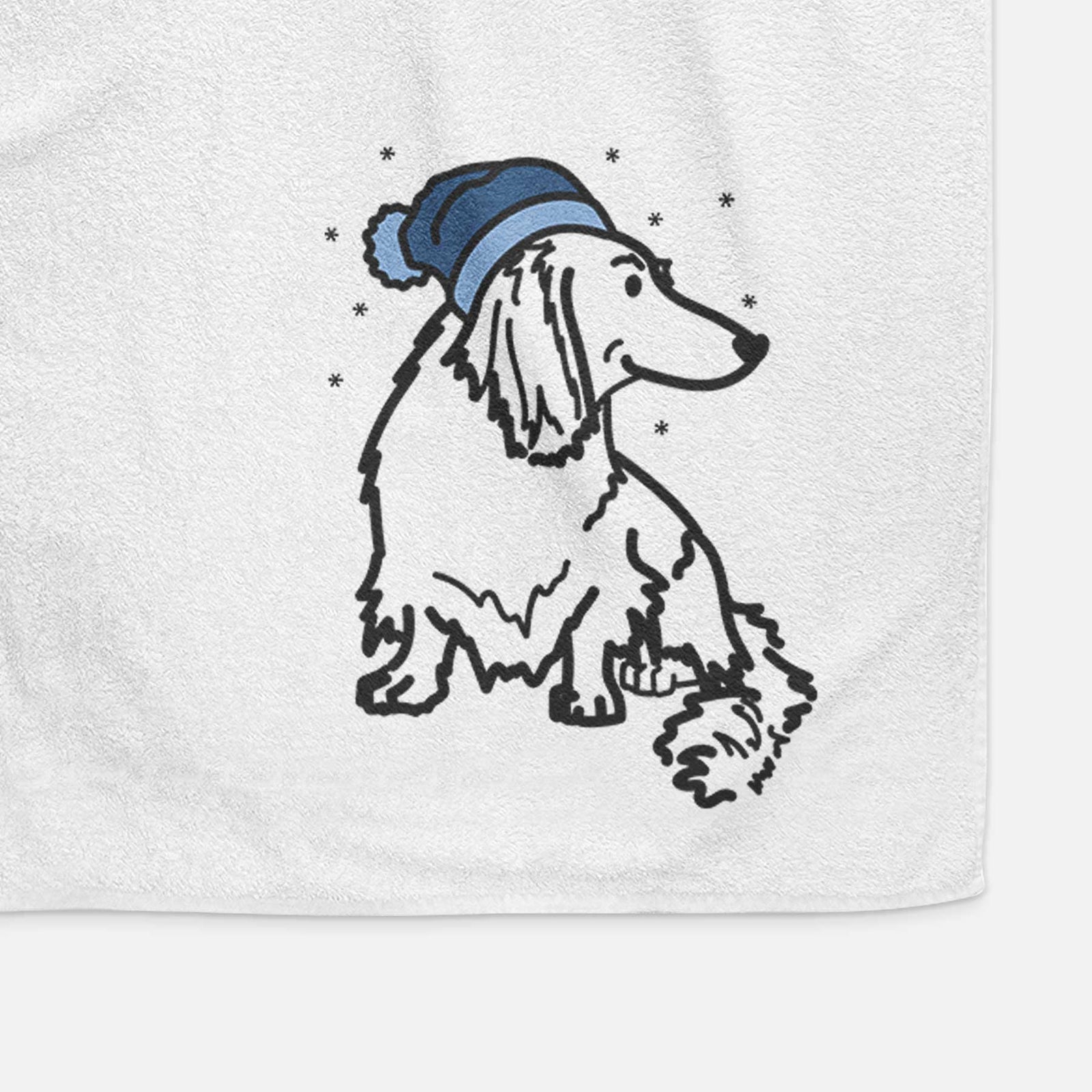 Minimalist line drawing of Bella the Dachshund wearing a winter beanie on a decorative hand towel