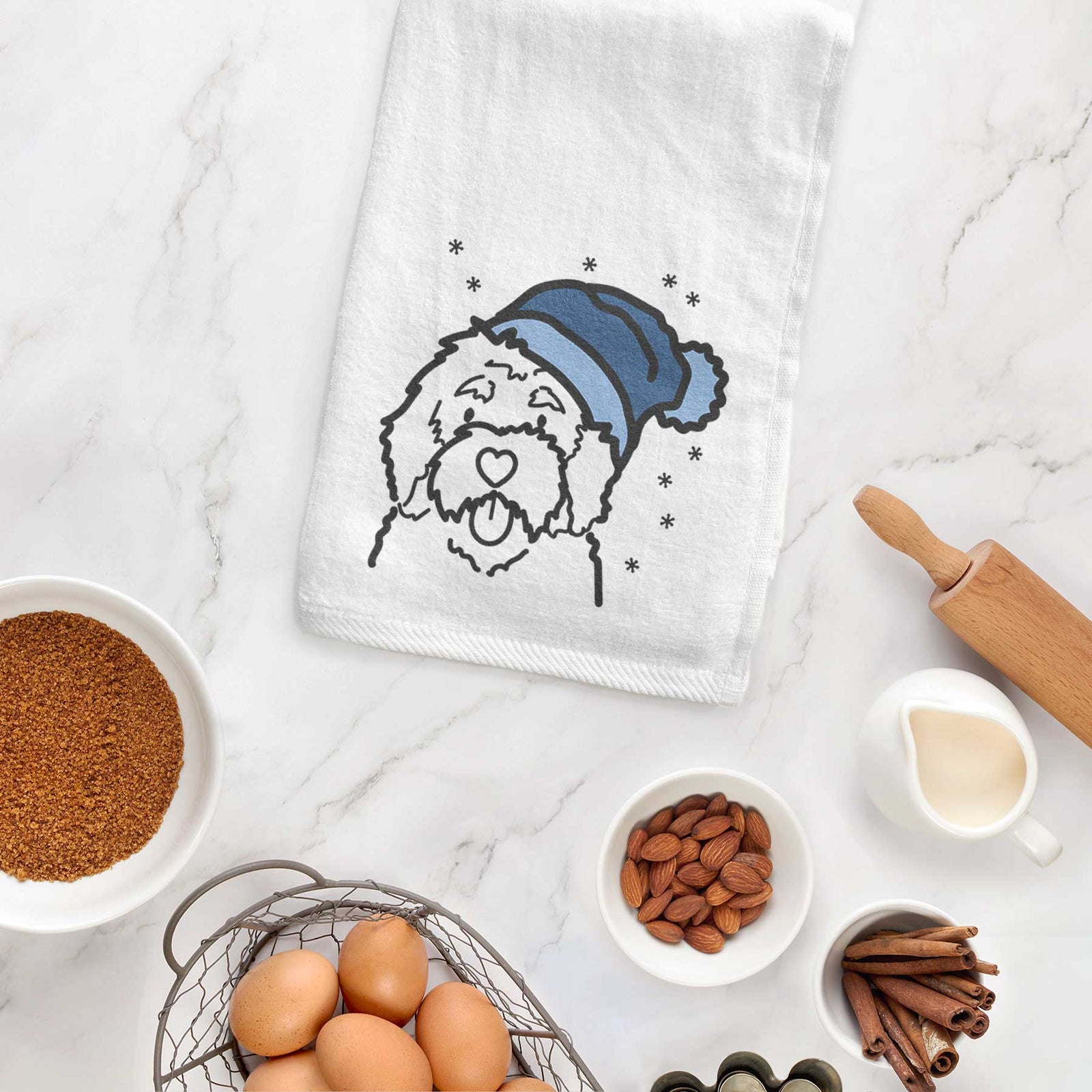 Minimalist line drawing of a Bernedoodle wearing a winter beanie on a decorative hand towel