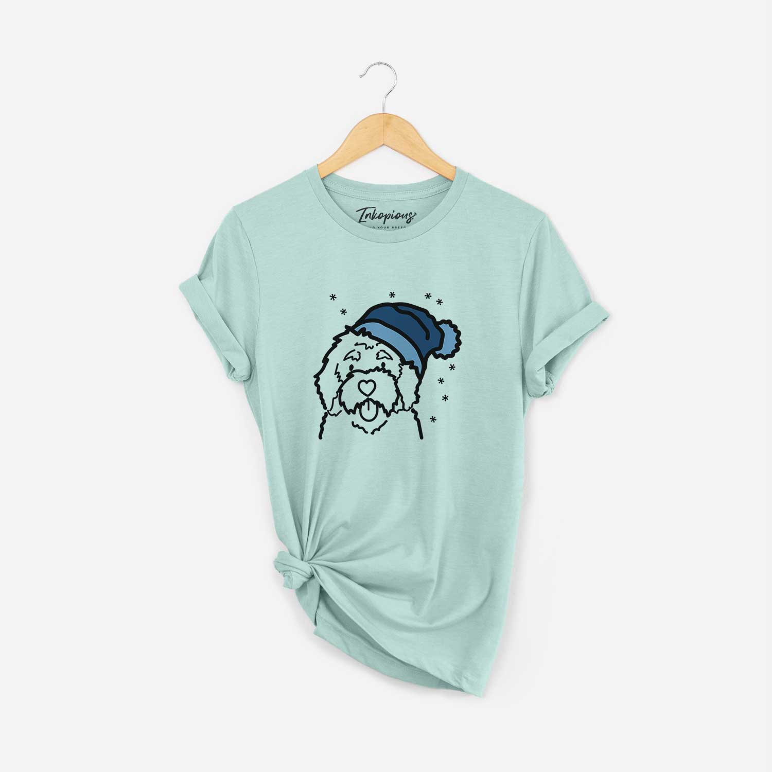 Minimalist line drawing of a Bernedoodle wearing a winter beanie on a Heather Sage Unisex crewneck