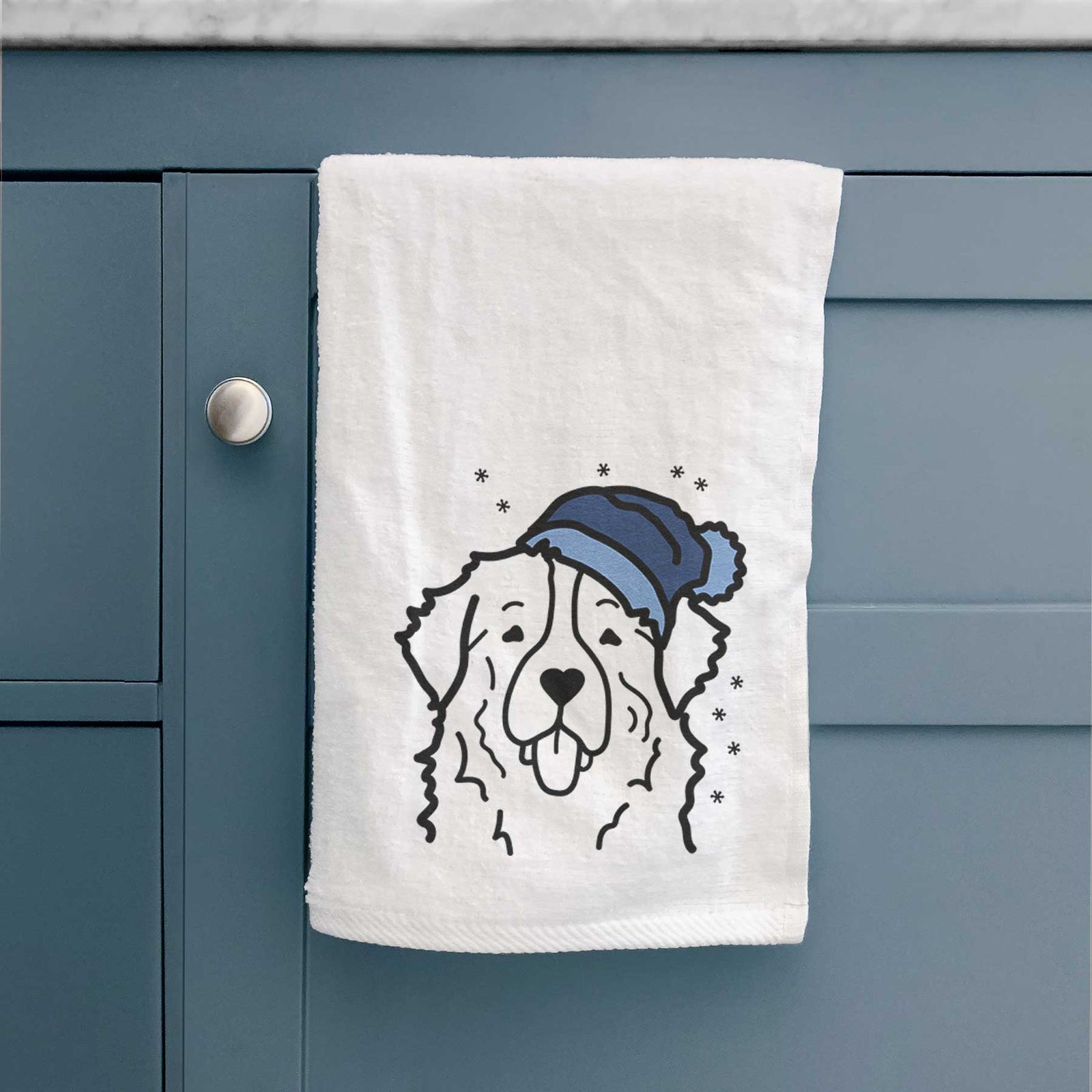 Minimalist line drawing of a Bernese Mountain Dog wearing a winter beanie on a decorative hand towel