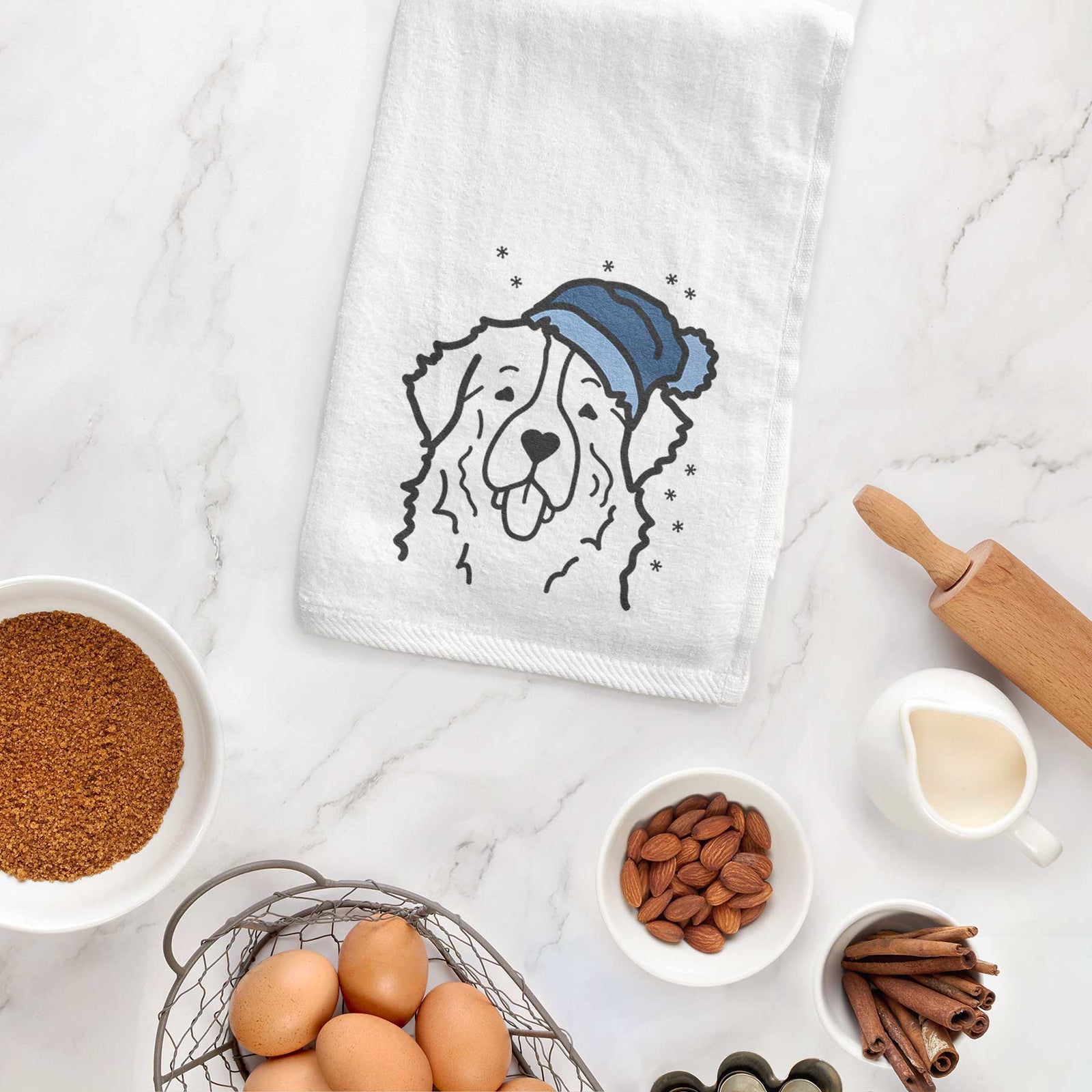 Minimalist line drawing of a Bernese Mountain Dog wearing a winter beanie on a decorative hand towel