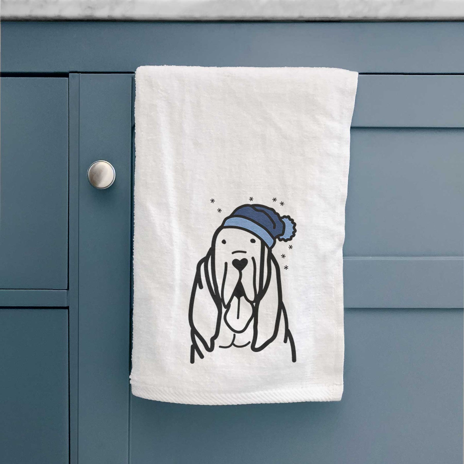 Minimalist line drawing of a Bloodhound wearing a winter beanie on a decorative hand towel