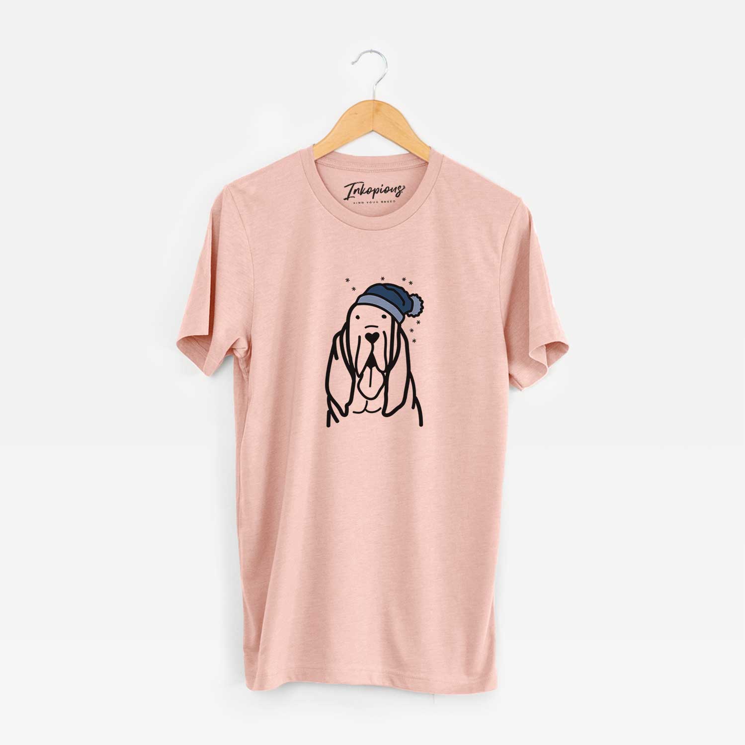 Minimalist line drawing of a Bloodhound wearing a winter beanie on a Peach Unisex crewneck