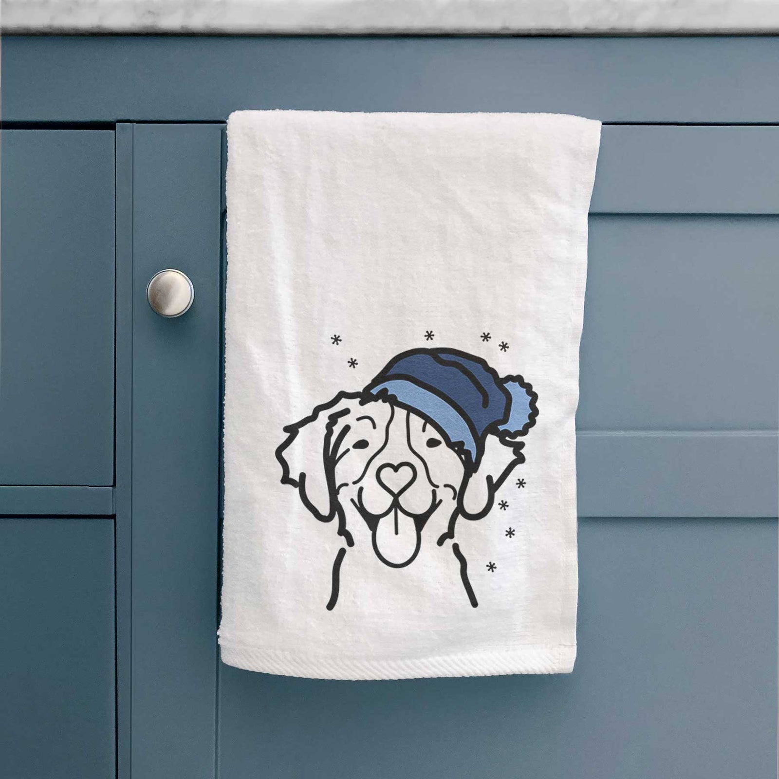 Minimalist line drawing of a Brittany wearing a winter beanie on a decorative hand towel