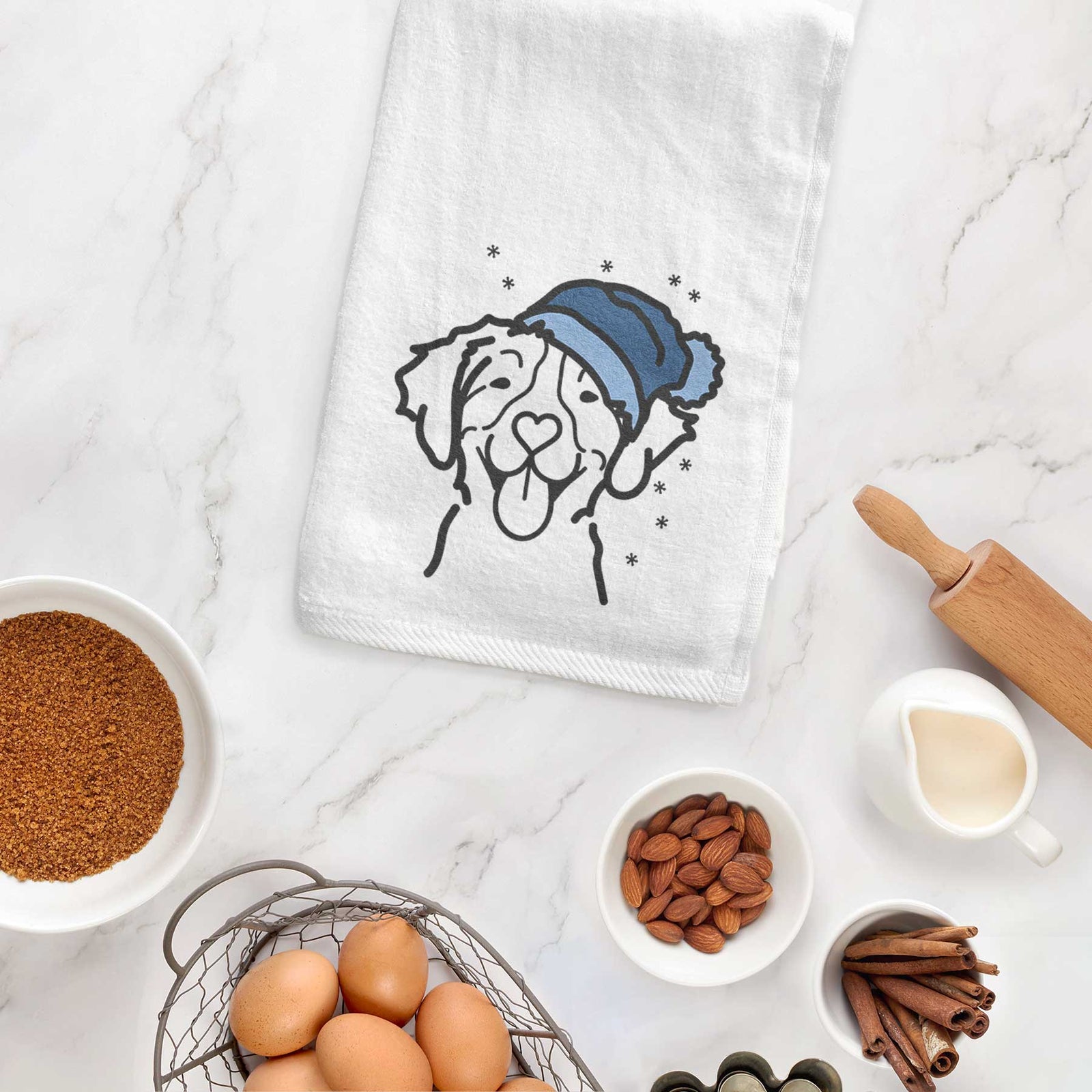 Minimalist line drawing of a Brittany wearing a winter beanie on a decorative hand towel