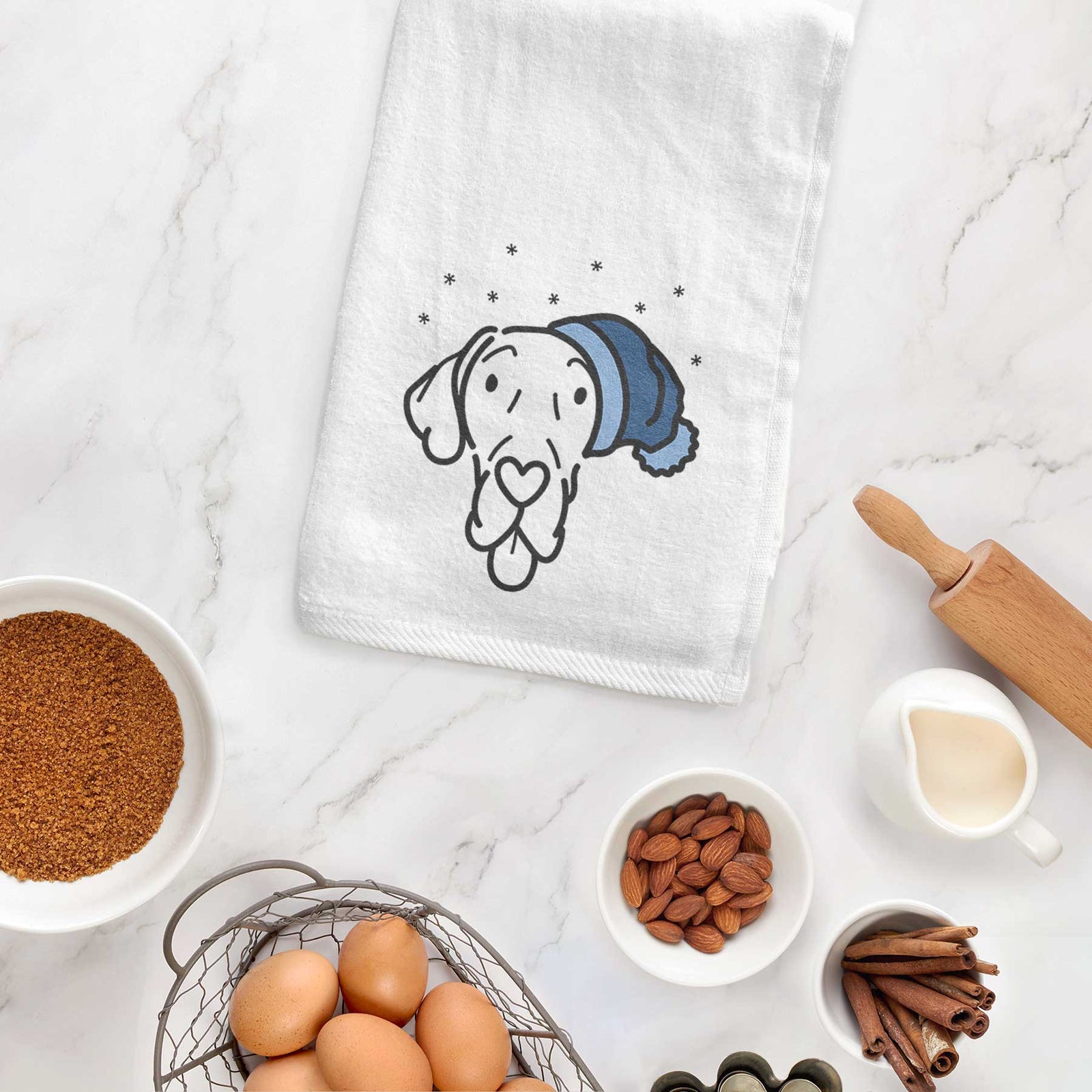Minimalist line drawing of Bruce the Great Dane wearing a winter beanie on a decorative hand towel
