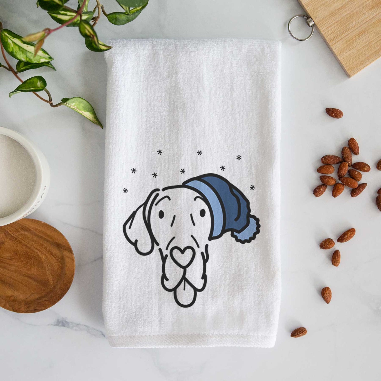 Minimalist line drawing of Bruce the Great Dane wearing a winter beanie on a decorative hand towel