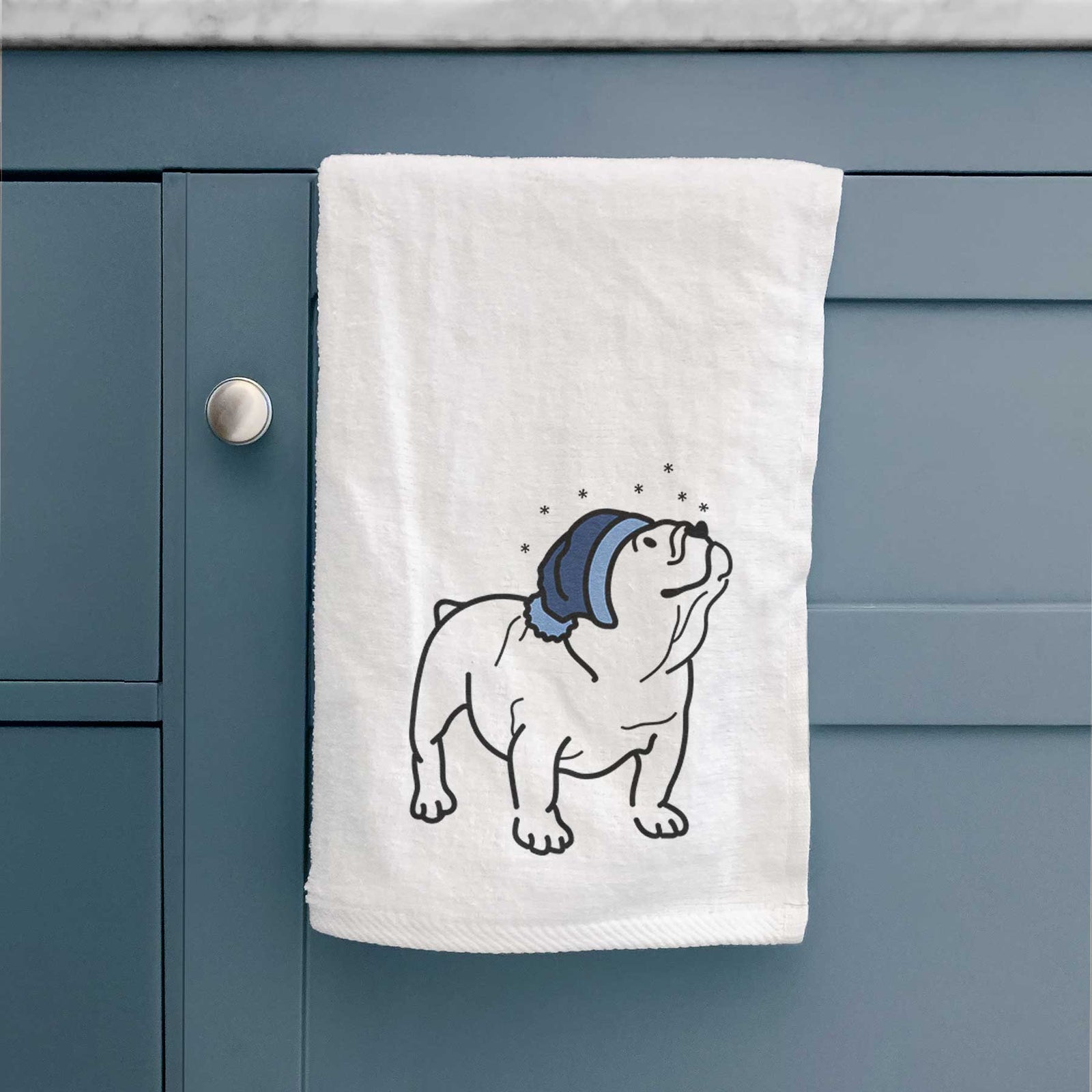 Minimalist line drawing of Bruno the English Bulldog wearing a winter beanie on a decorative hand towel
