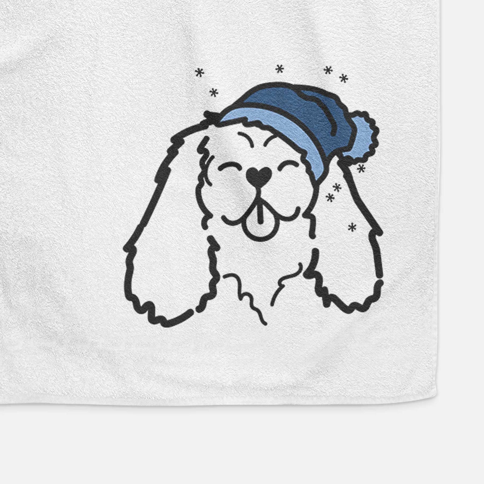 Minimalist line drawing of a Cavalier King Charles Spaniel wearing a winter beanie on a decorative hand towel