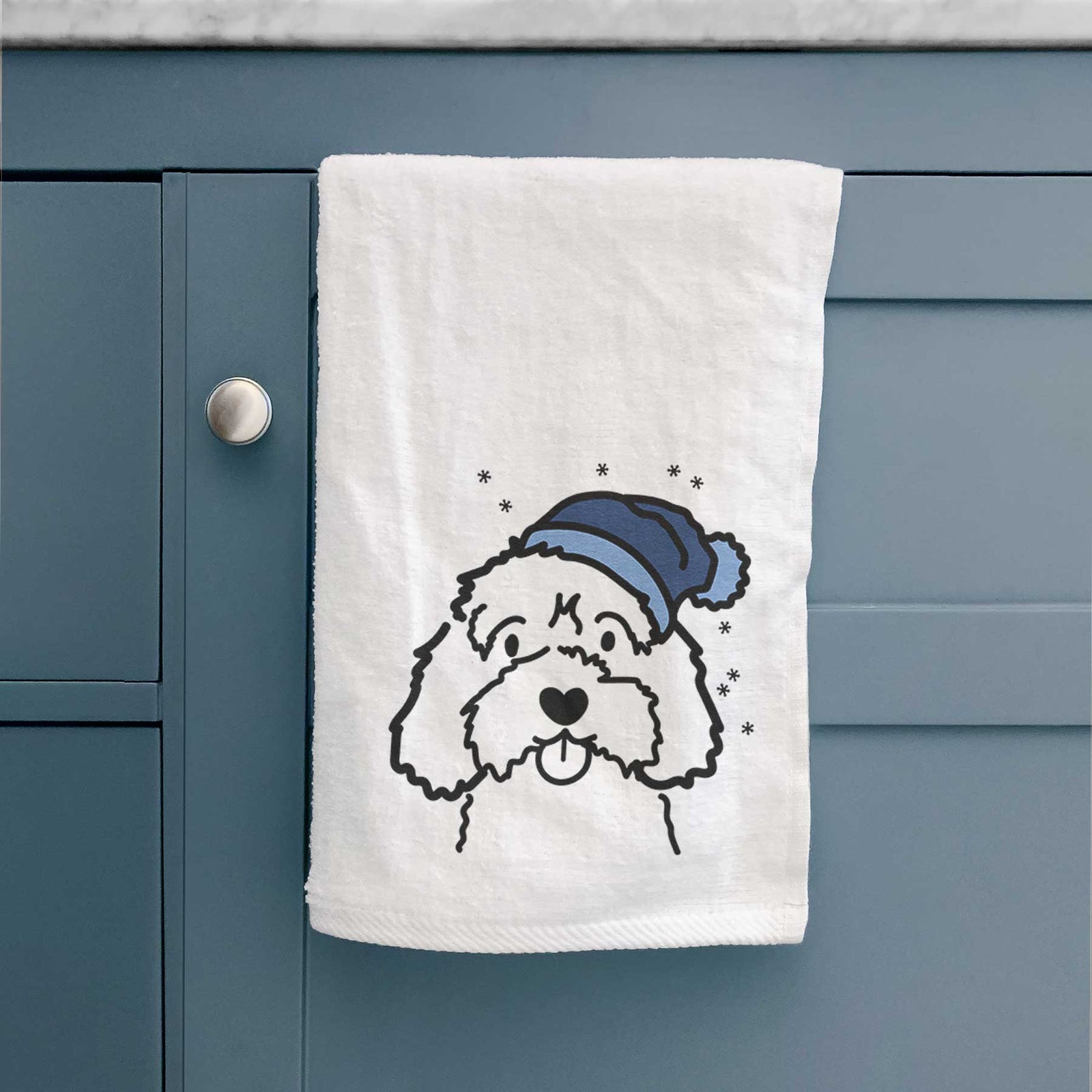 Minimalist line drawing of a Cavapoo wearing a winter beanie on a decorative hand towel