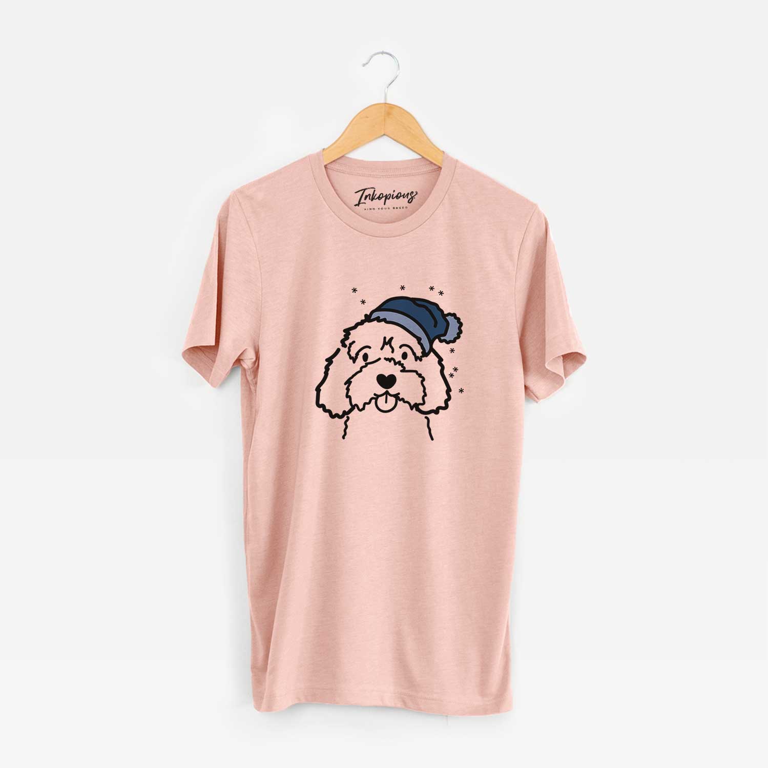 Minimalist line drawing of a Cavapoo wearing a winter beanie on a Peach Unisex crewneck