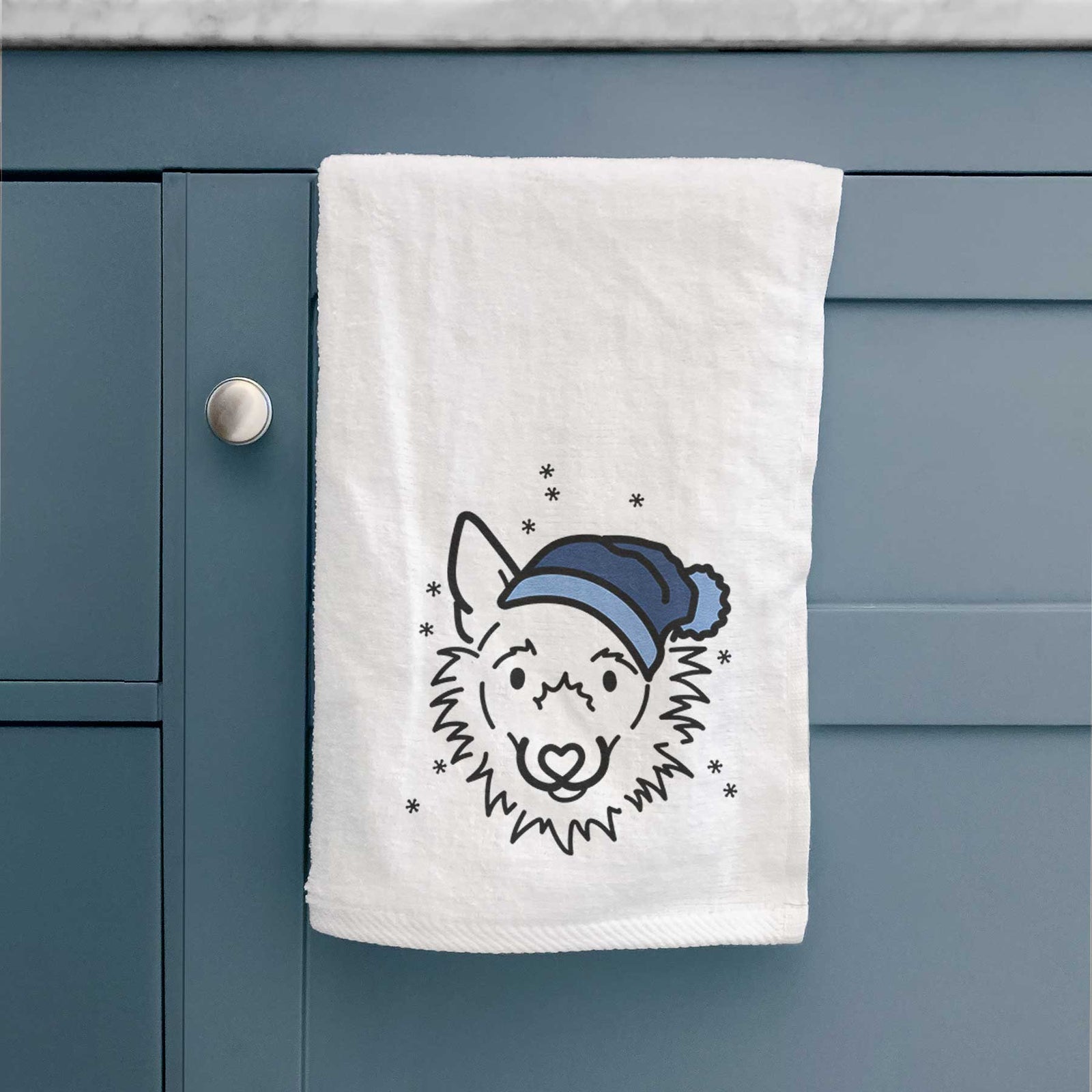 Minimalist line drawing of Chewy the Super Mutt wearing a winter beanie on a decorative hand towel