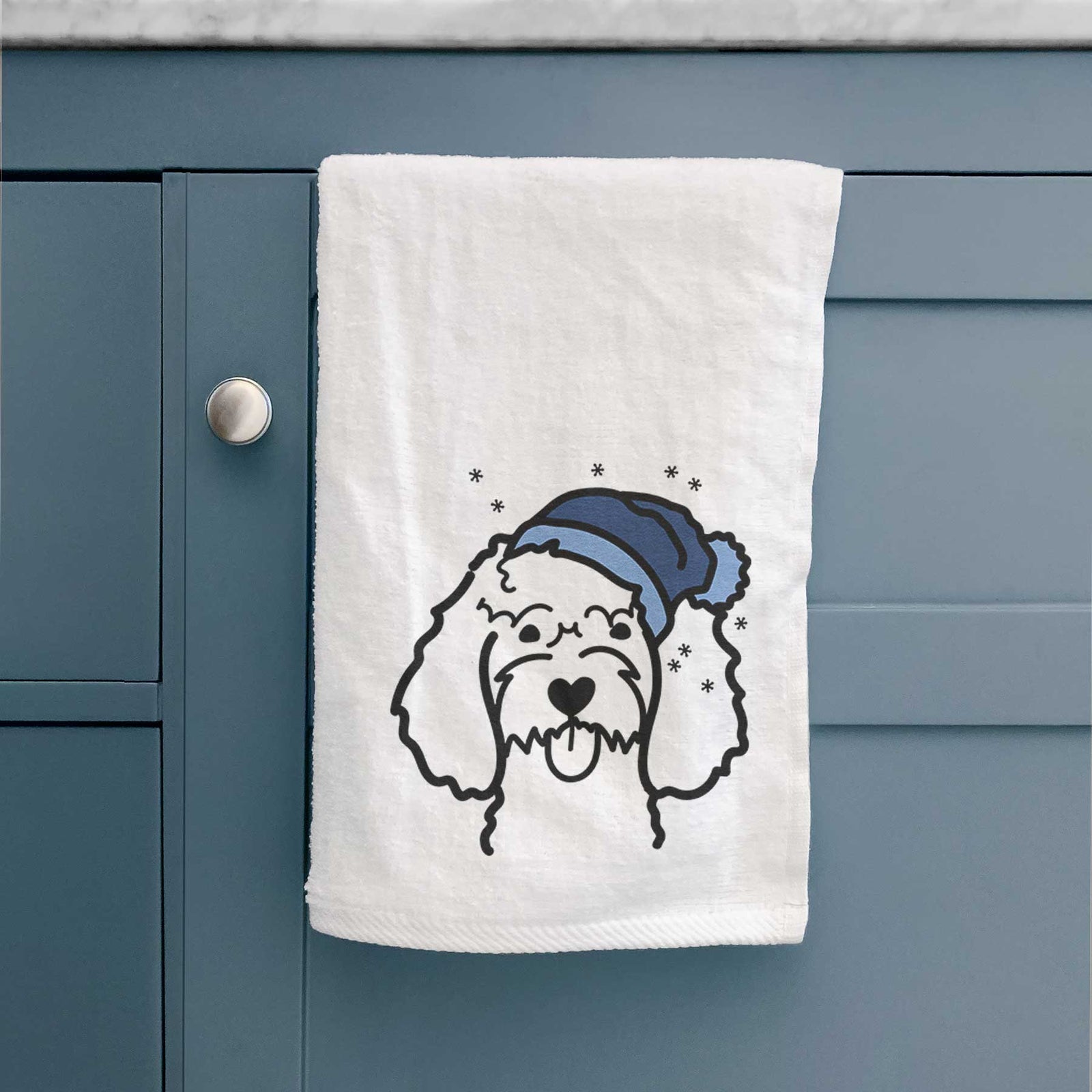 Minimalist line drawing of a Cockapoo wearing a winter beanie on a decorative hand towel