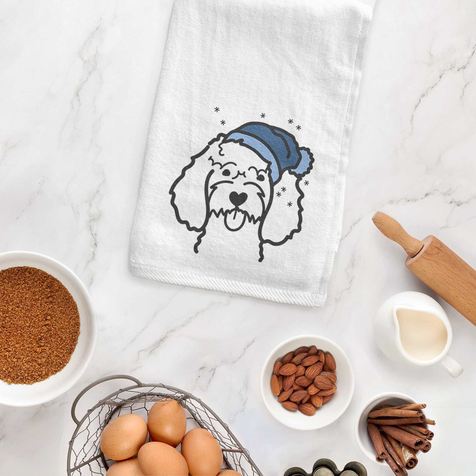 Minimalist line drawing of a Cockapoo wearing a winter beanie on a decorative hand towel