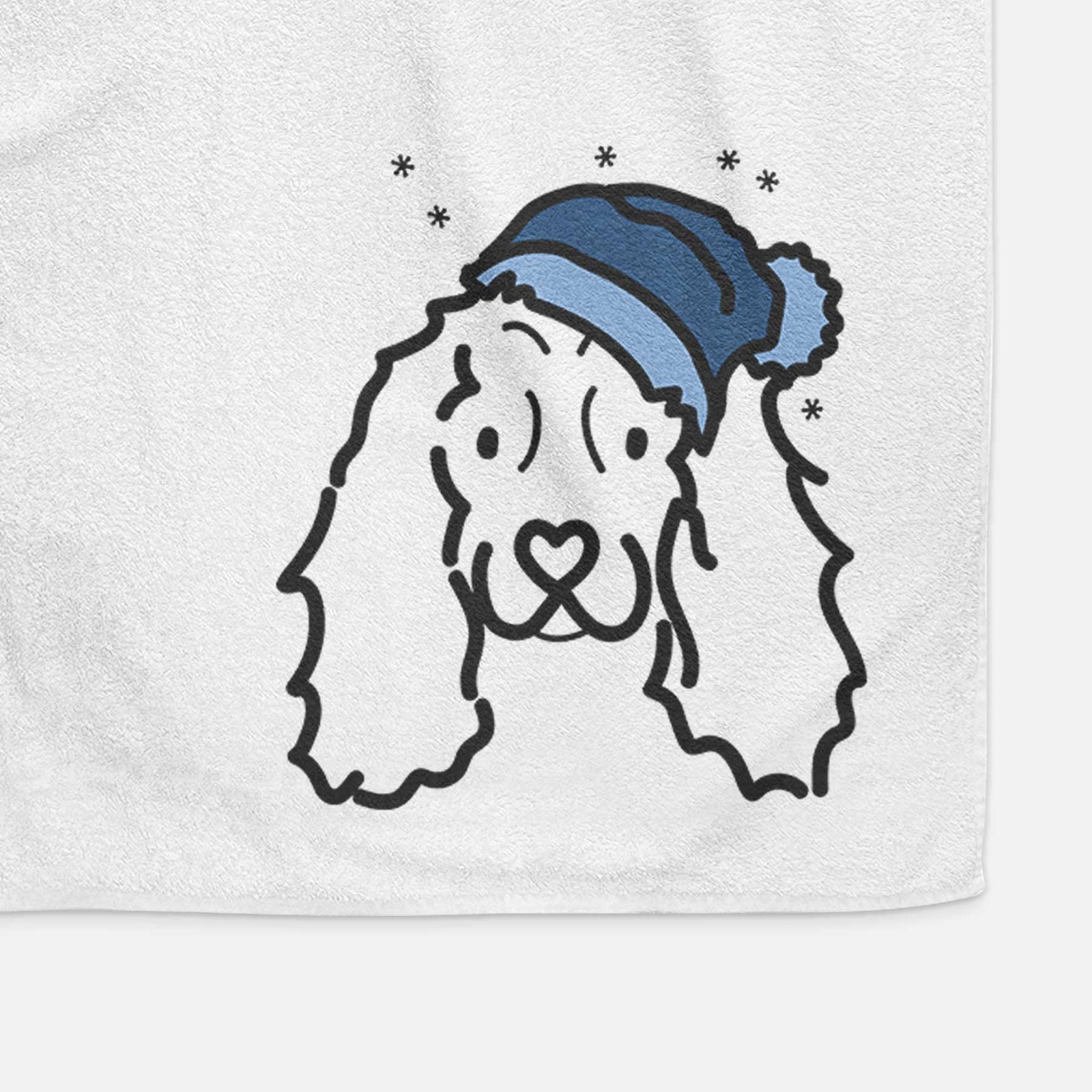 Minimalist line drawing of an American Cocker Spaniel wearing a winter beanie on a decorative hand towel