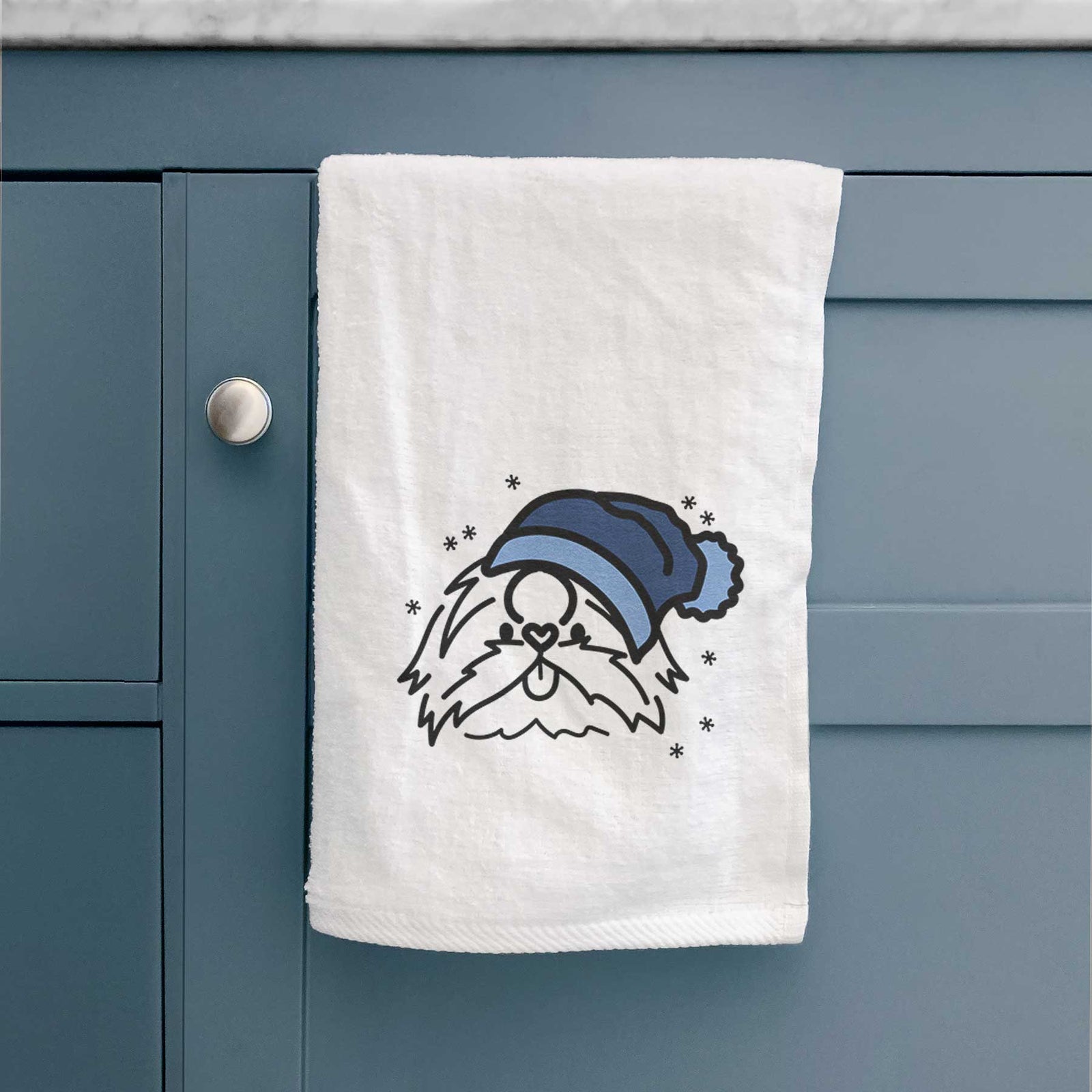 Minimalist line drawing of CoCo the Shih Tzu wearing a winter beanie on a decorative hand towel