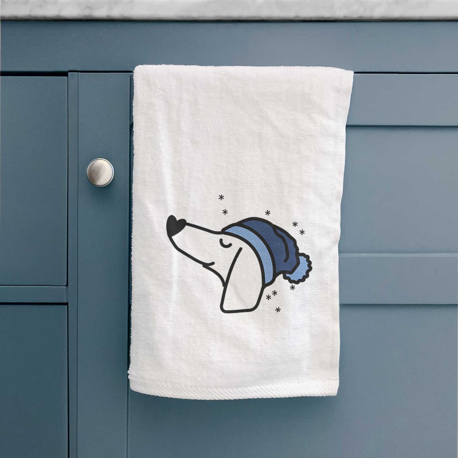 Minimalist line drawing of a Dachshund wearing a winter beanie on a decorative hand towel