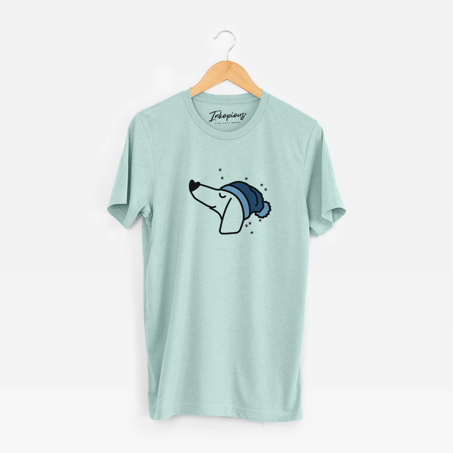 Minimalist line drawing of a Dachshund wearing a winter beanie on a Heather Sage Unisex crewneck
