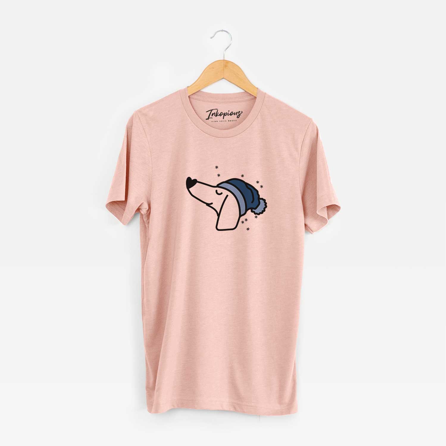 Minimalist line drawing of a Dachshund wearing a winter beanie on a Peach Unisex crewneck
