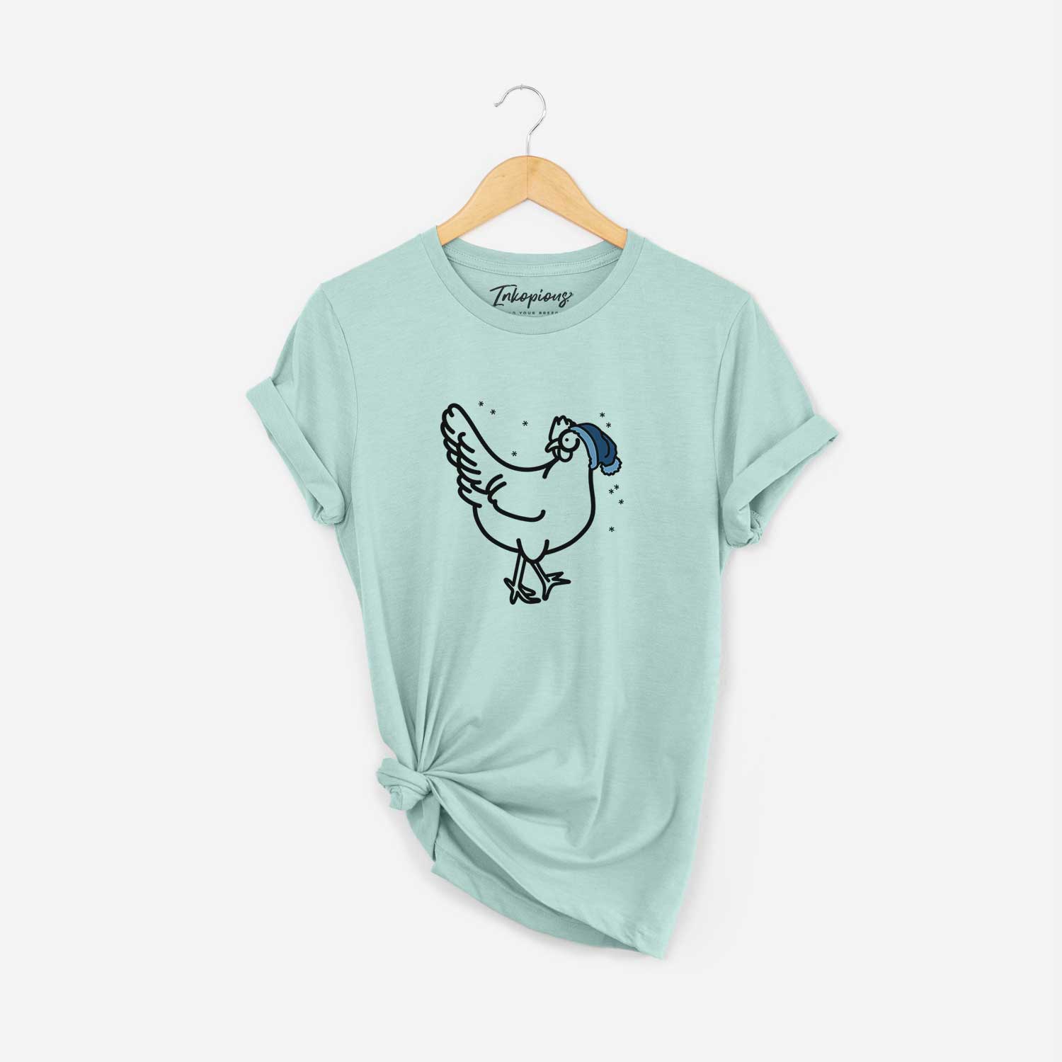 Minimalist line drawing of Daisy the Chicken wearing a winter beanie on a Heather Sage Unisex crewneck