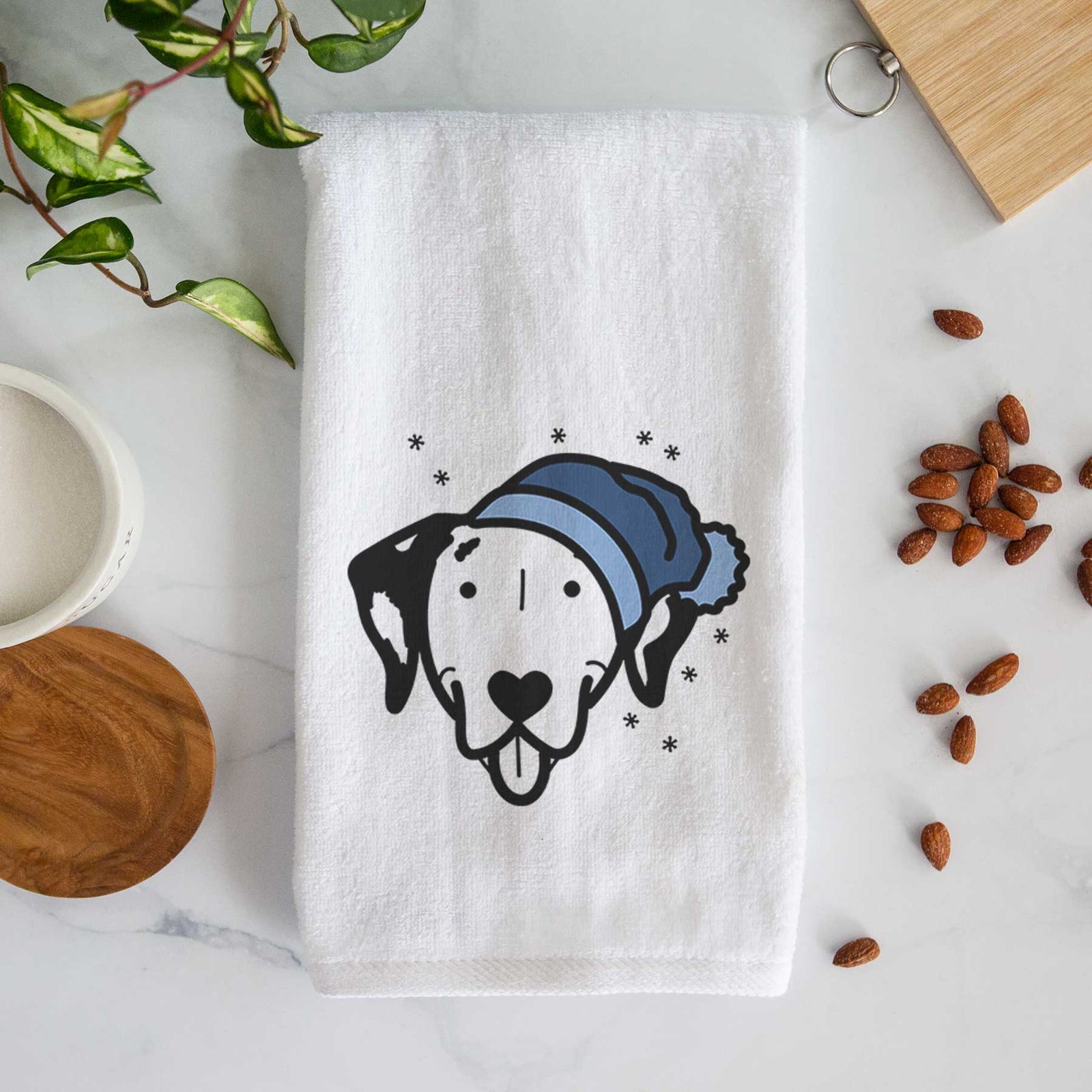 Minimalist line drawing of a Dalmatian wearing a winter beanie on a decorative hand towel