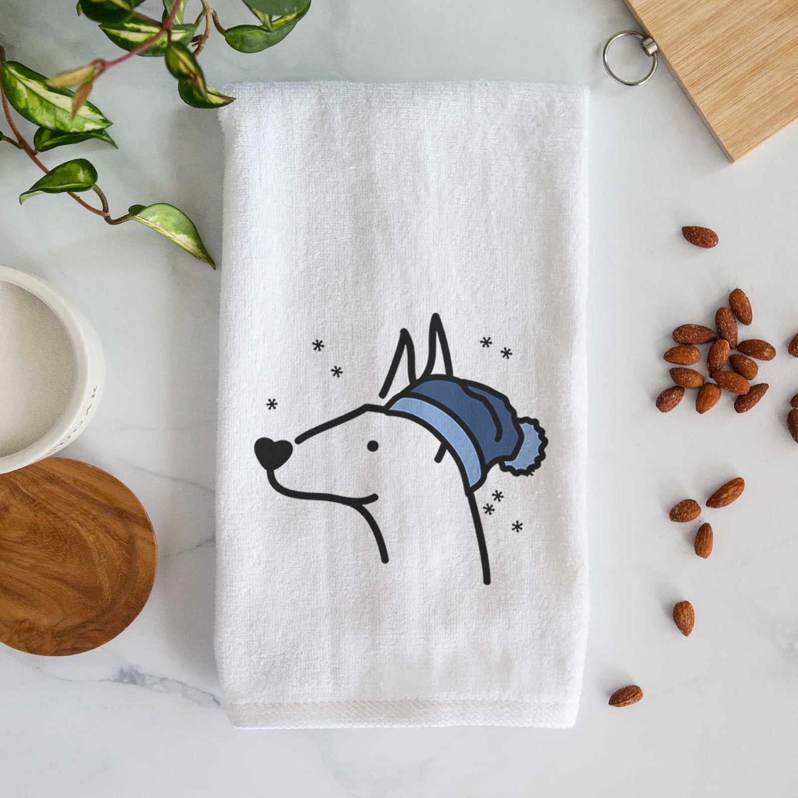 Minimalist line drawing of a Doberman Pinscher wearing a winter beanie on a decorative hand towel
