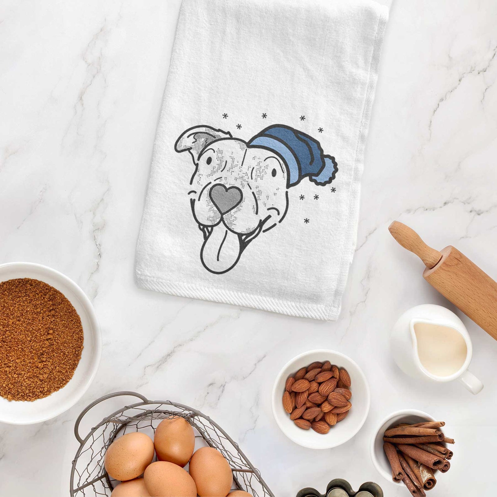 Minimalist line drawing of Dottie the Pitbull Mix wearing a winter beanie on a decorative hand towel