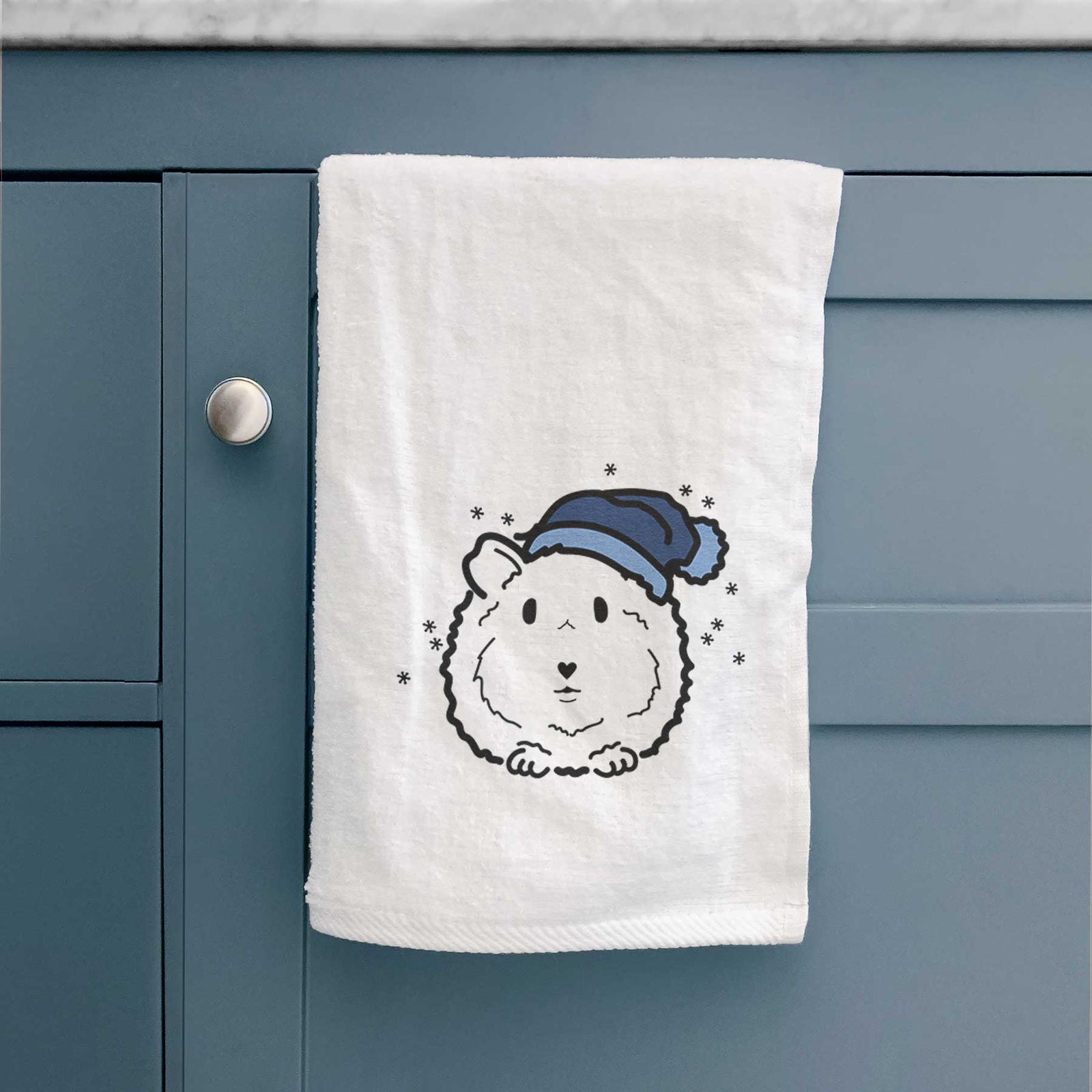 Minimalist line drawing of Duke the Guinea Pig wearing a winter beanie on a decorative hand towel
