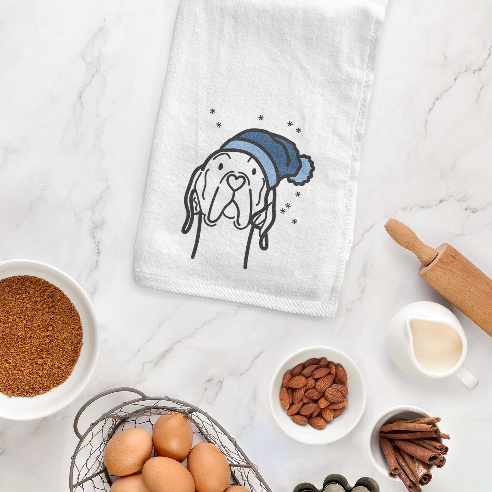 Minimalist line drawing of an English Pointer wearing a winter beanie on a decorative hand towel