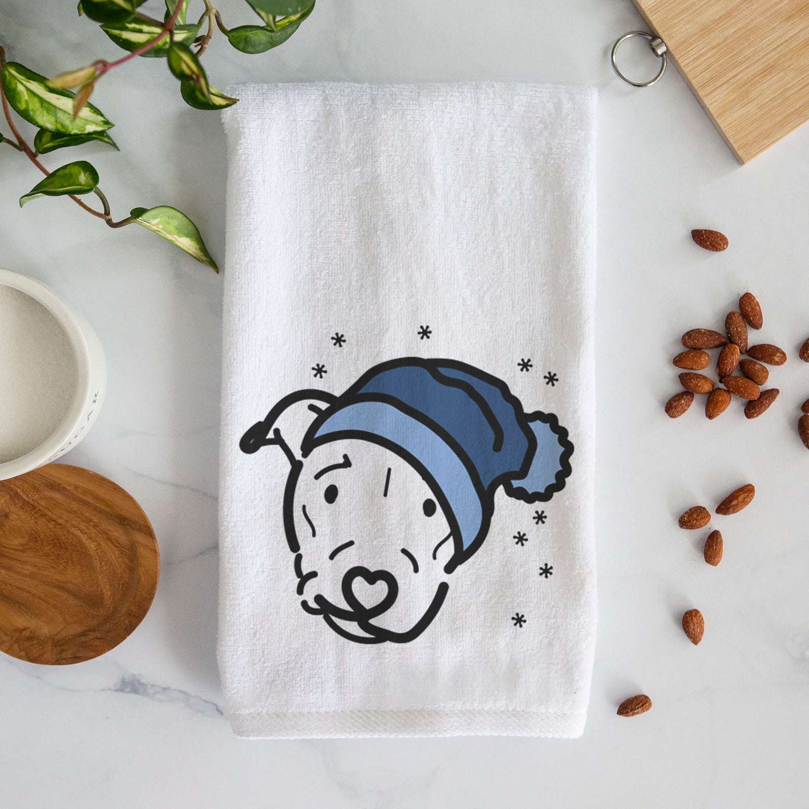 Minimalist line drawing of Ernie the Pitbull Mix wearing a winter beanie on a decorative hand towel